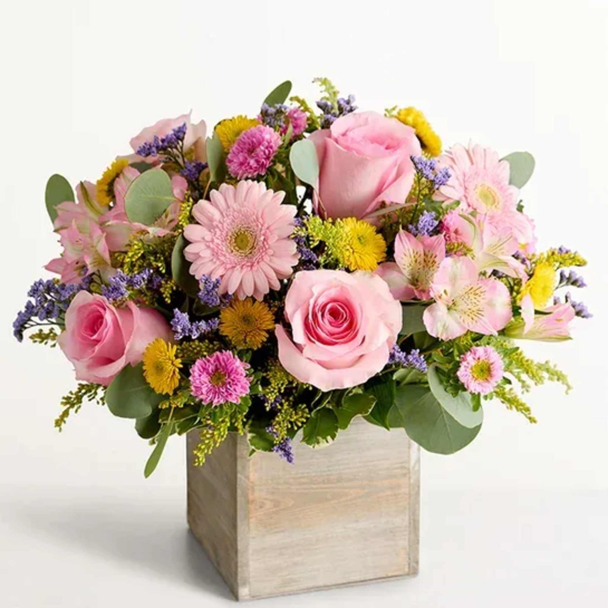 Pink roses and mixed pastel flowers in a wooden box