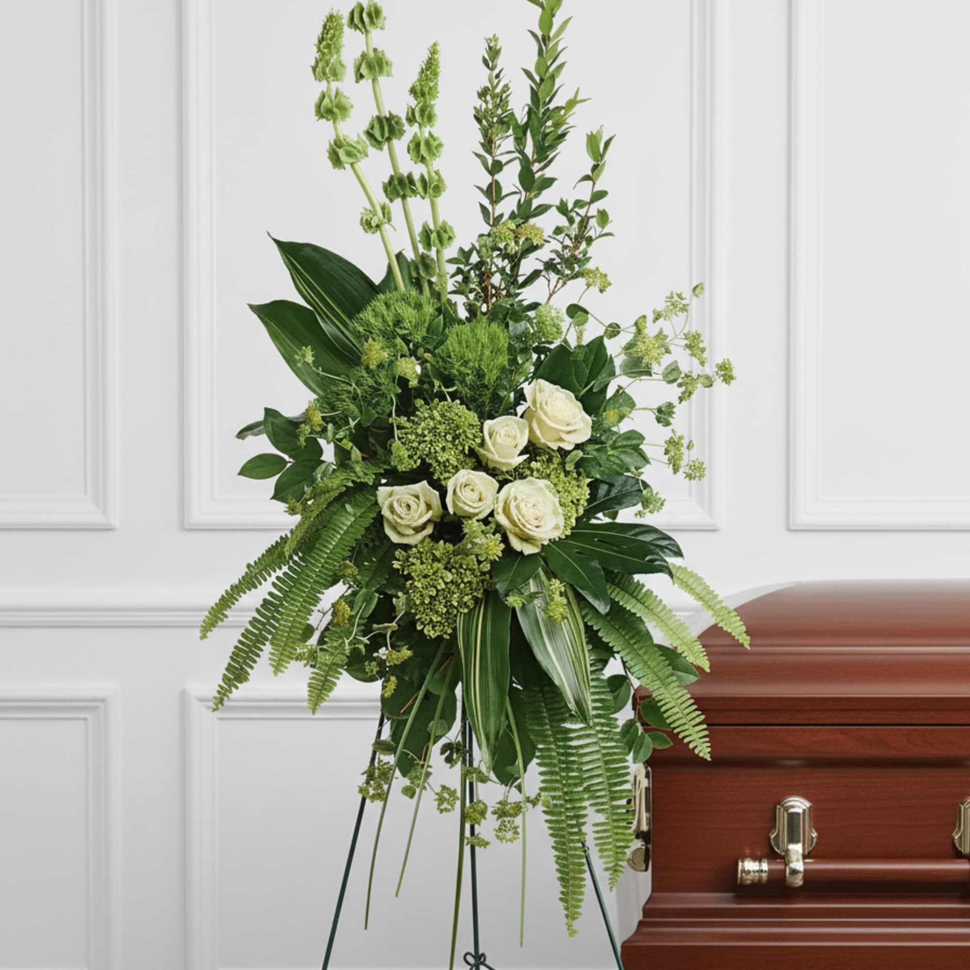 A peaceful display of affection and sympathy, this monochromatic spray of gorgeous