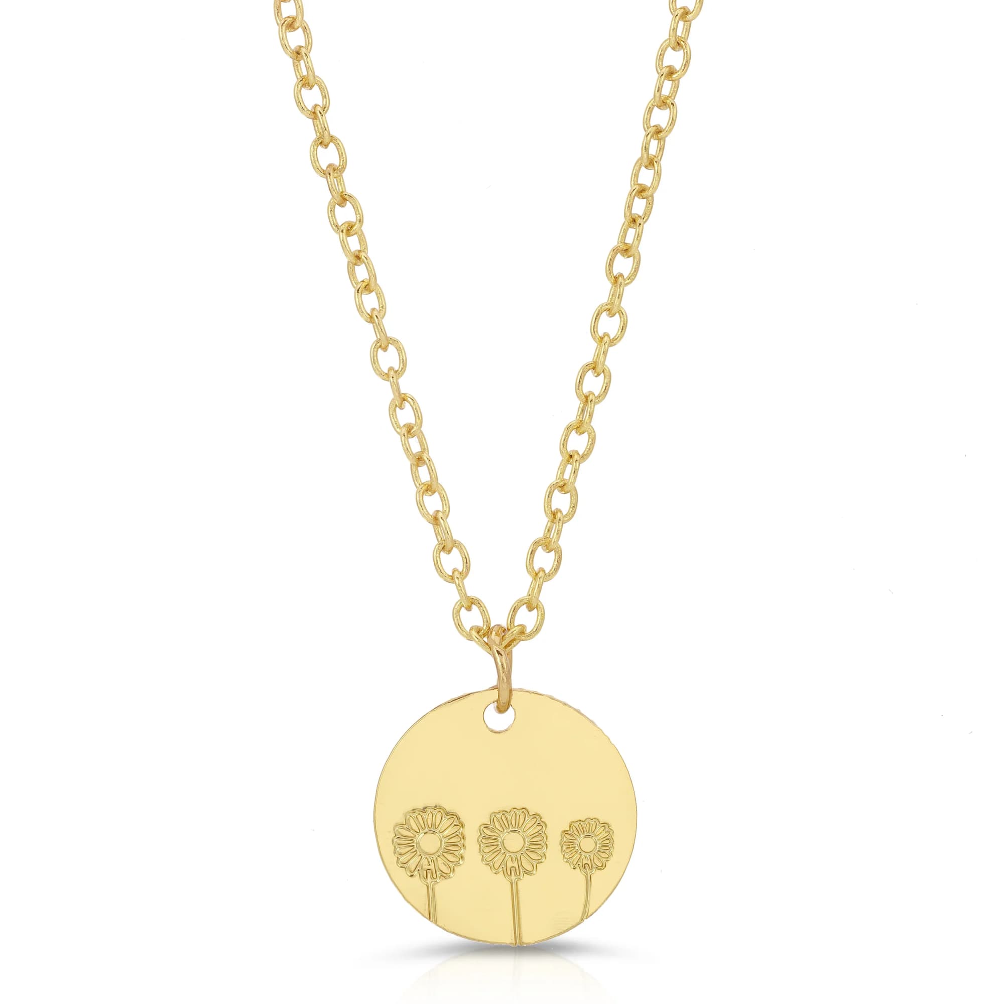 Gold necklace with a round pendant engraved with three small flowers.