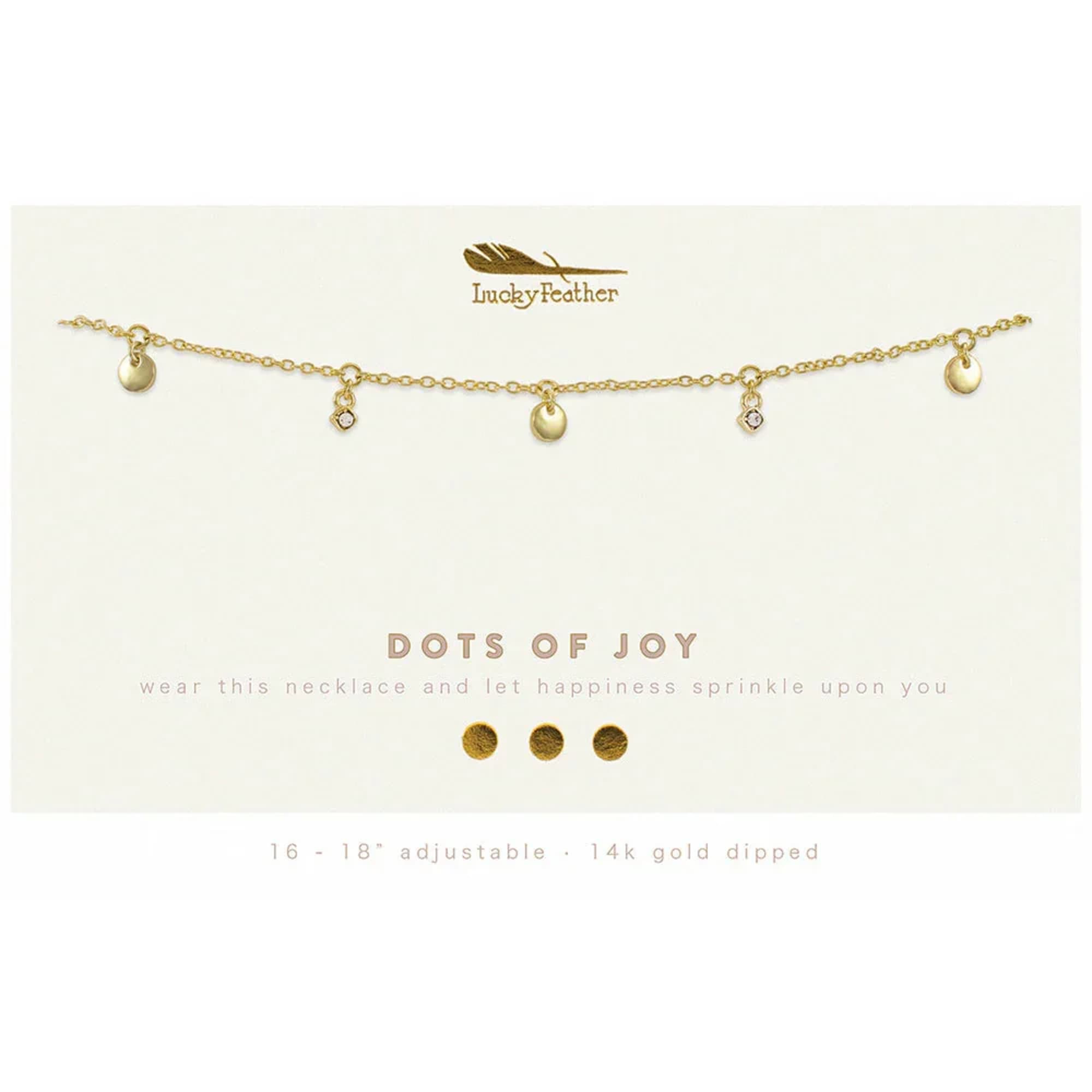 Gold charm necklace with small discs and crystal accents on a branded display card