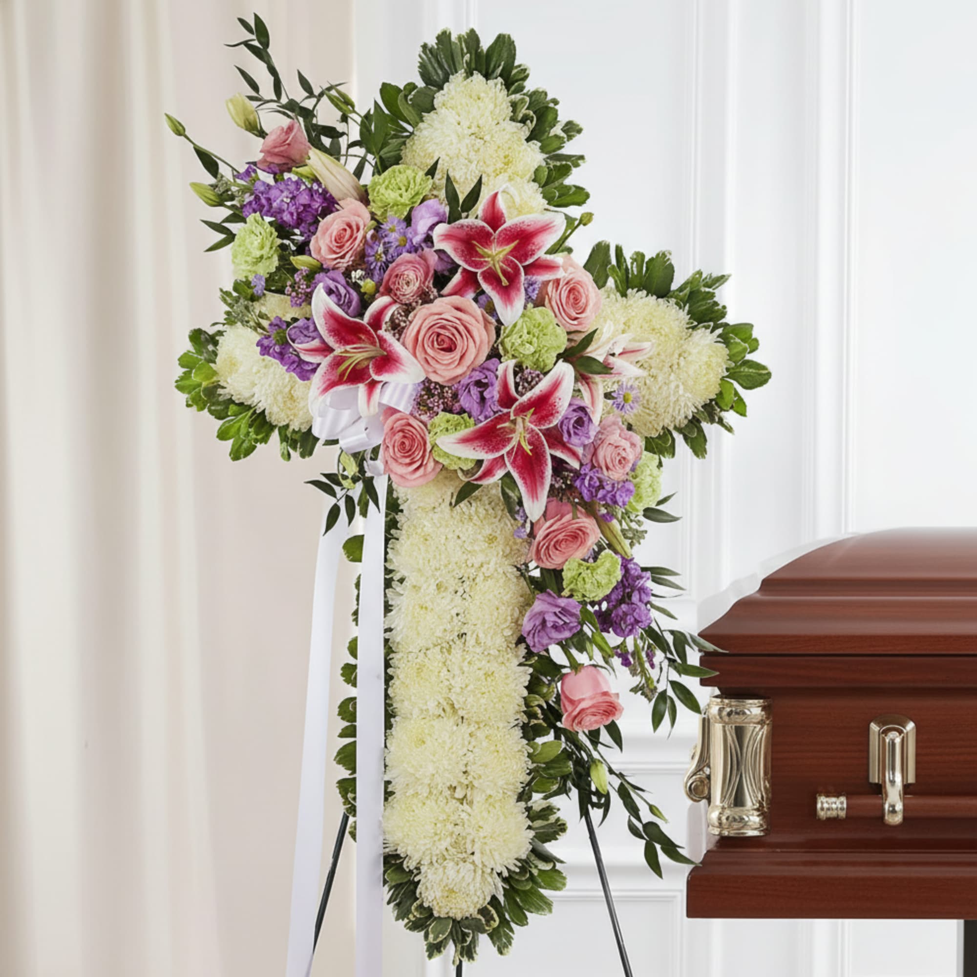 Standing funeral spray with pink lilies, roses, and white flowers