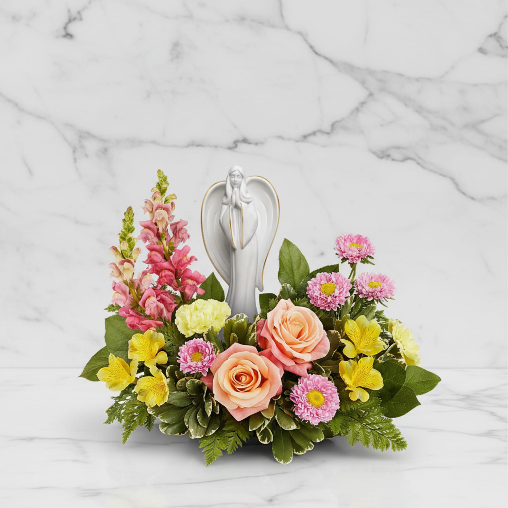 Radiating grace and serenity, our Angelic Bloom Bouquet surrounds a keepsake porcelain