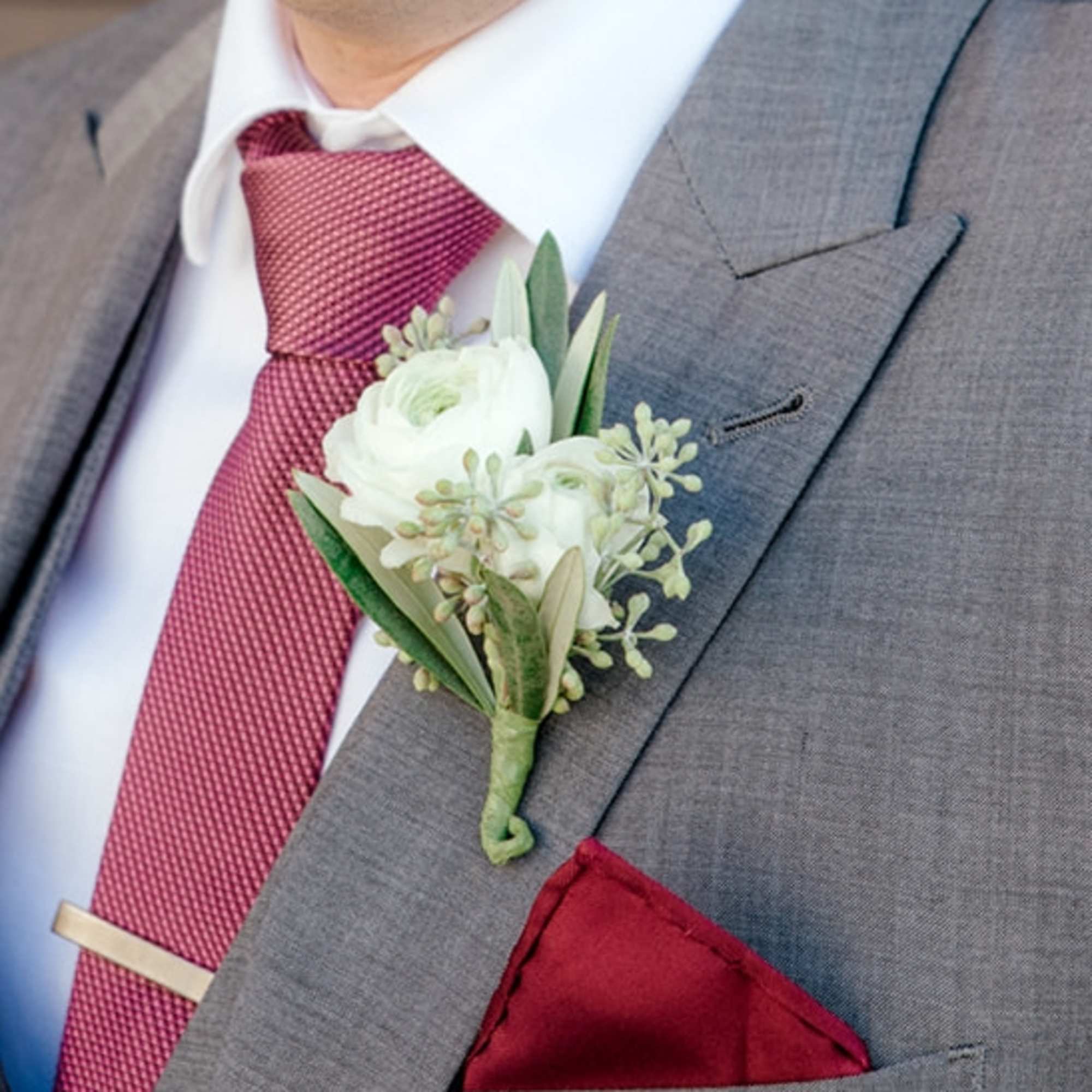 White boutonniere on a gray suit jacket