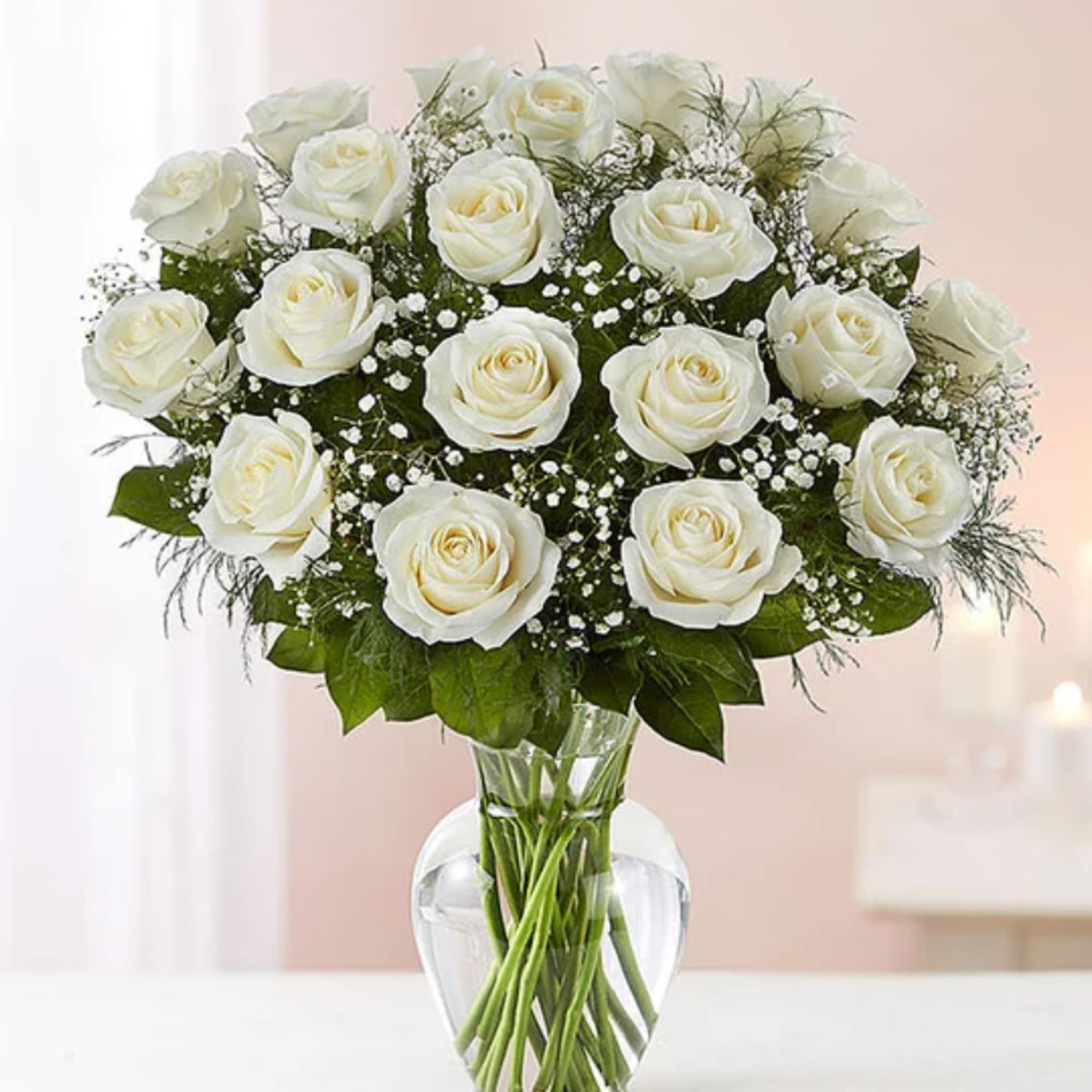 White roses arranged in a clear glass vase