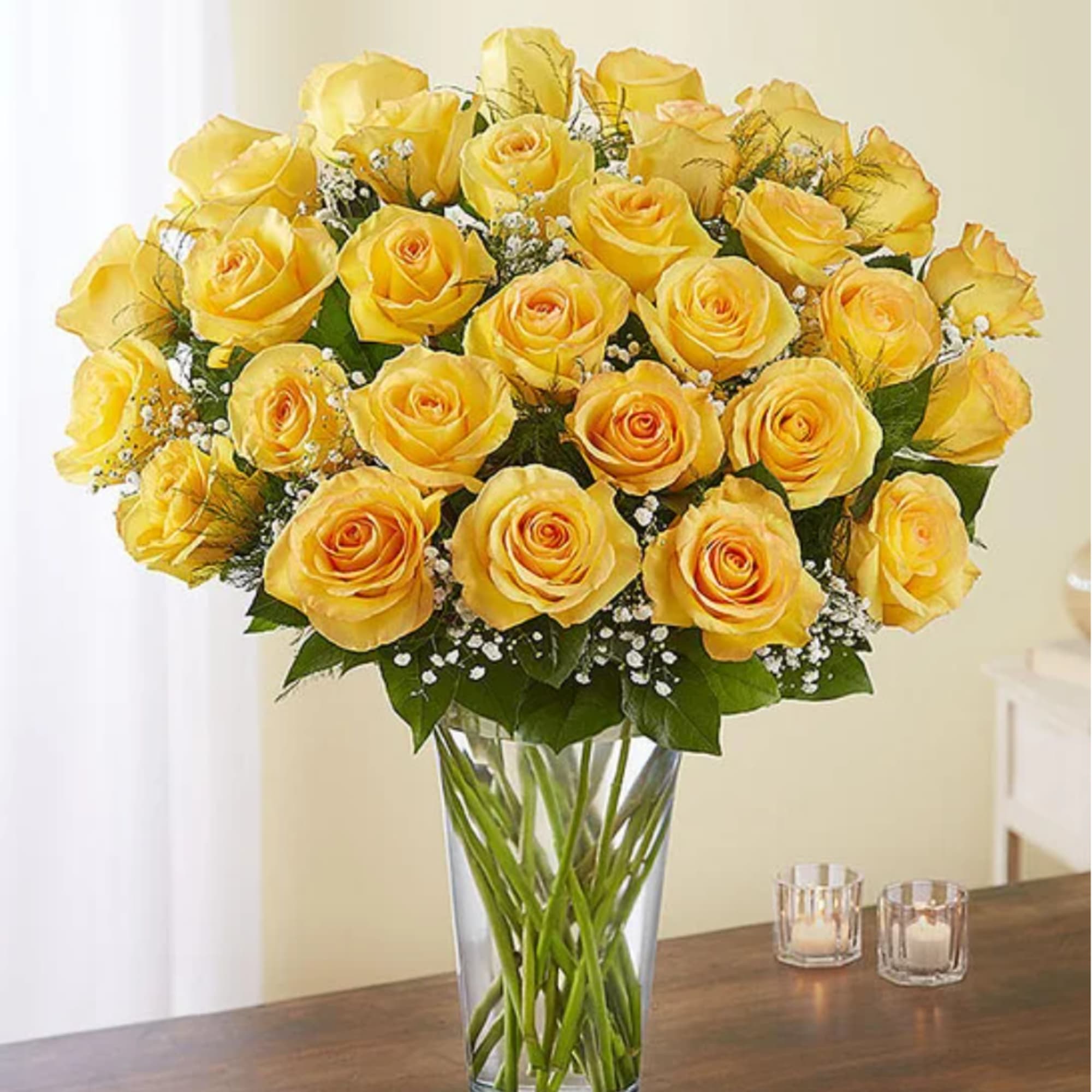 Yellow roses arranged in a clear glass vase