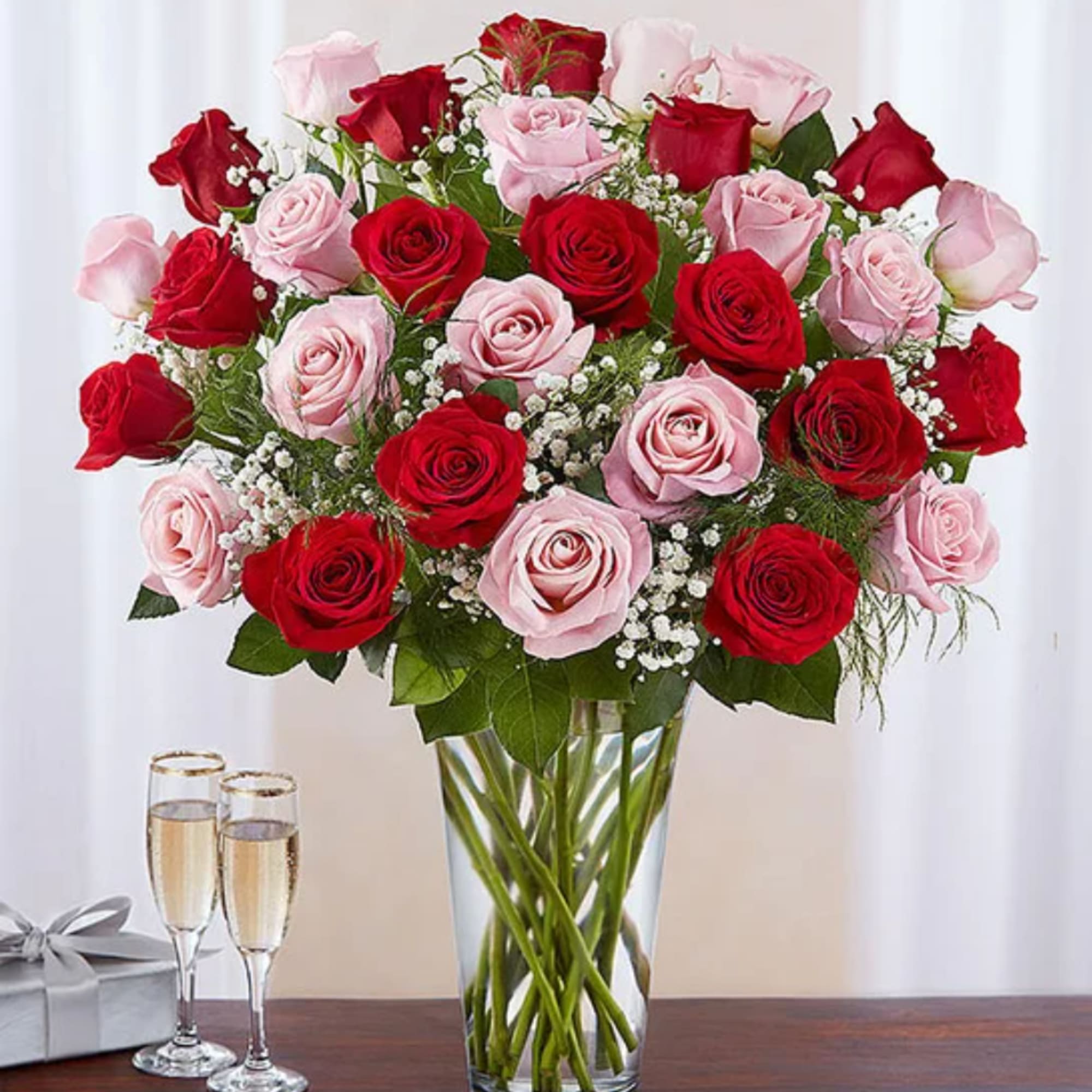 Bouquet of red and pink roses in a clear glass vase