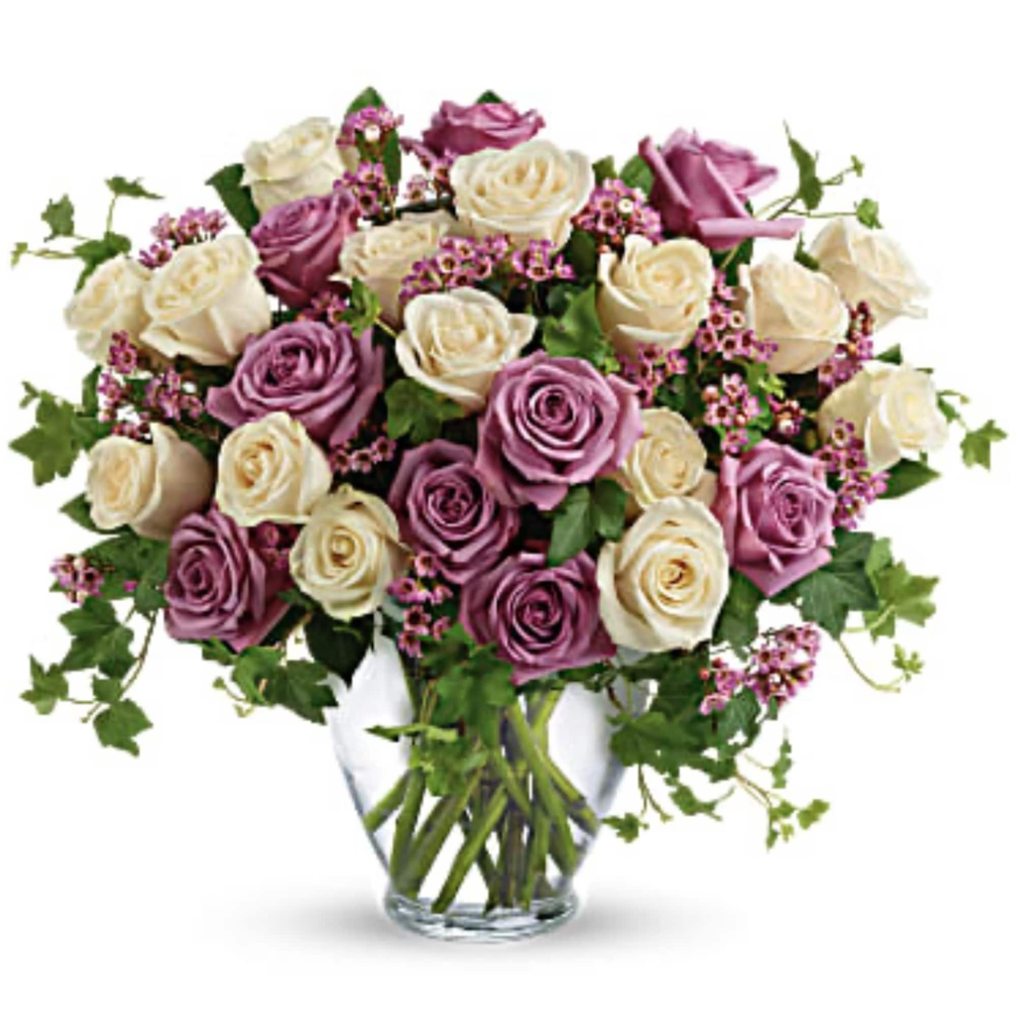 Bouquet of pink and cream roses in a clear glass vase