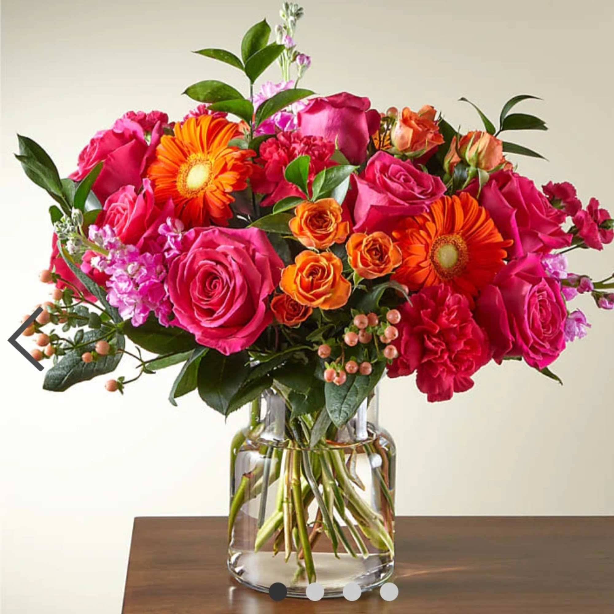 Bouquet of pink and orange flowers in a clear glass vase
