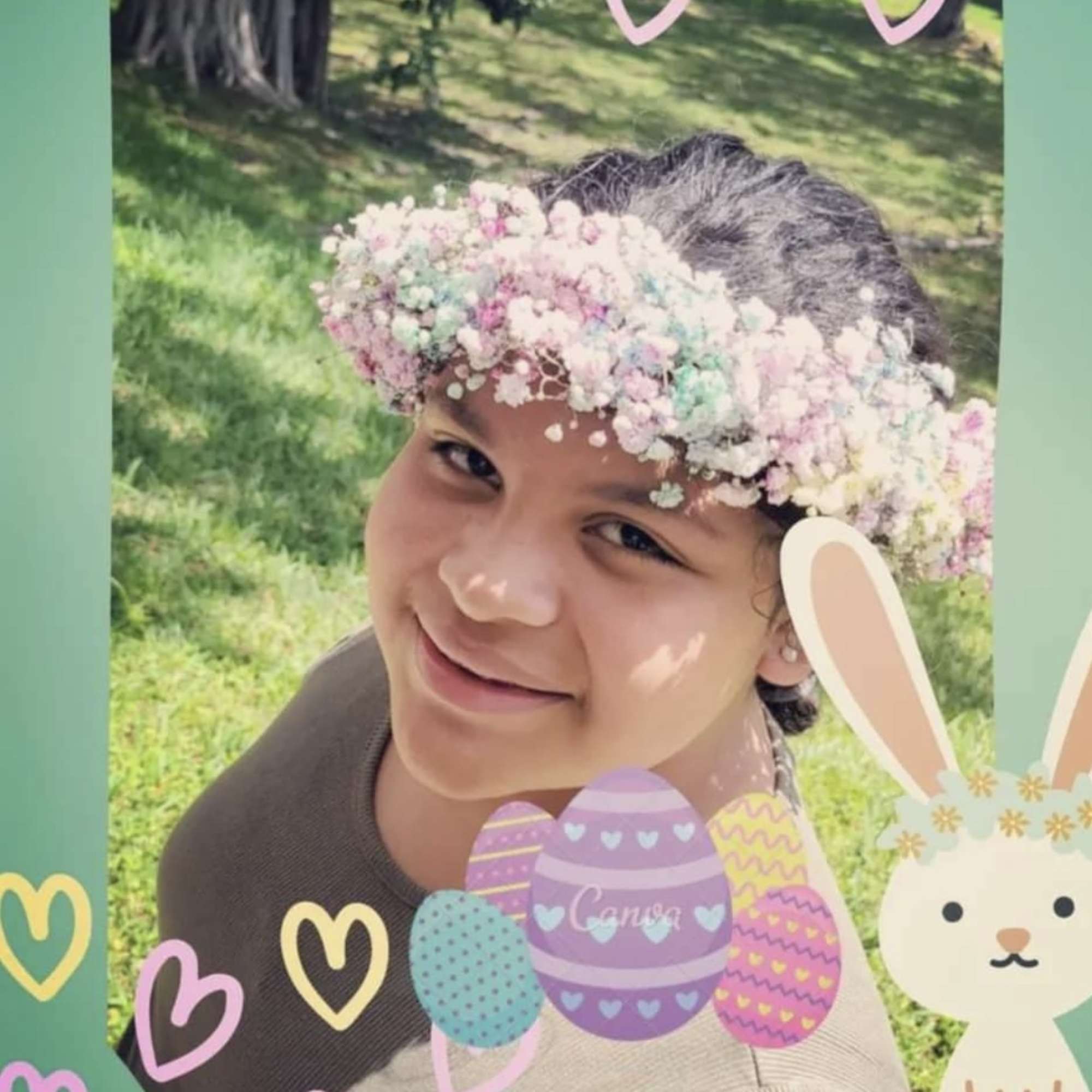 Child wearing a pastel flower crown outdoors with Easter decorations