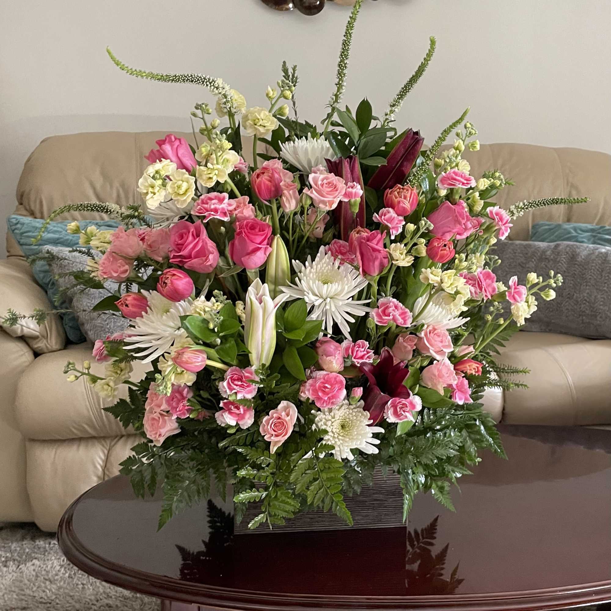 Large pink and white mixed flower arrangement in a rectangular container