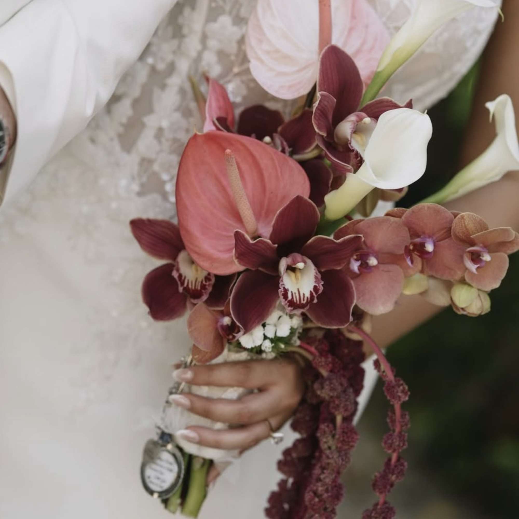 Wedding bouquet with pink anthuriums, orchids, and white calla lilies