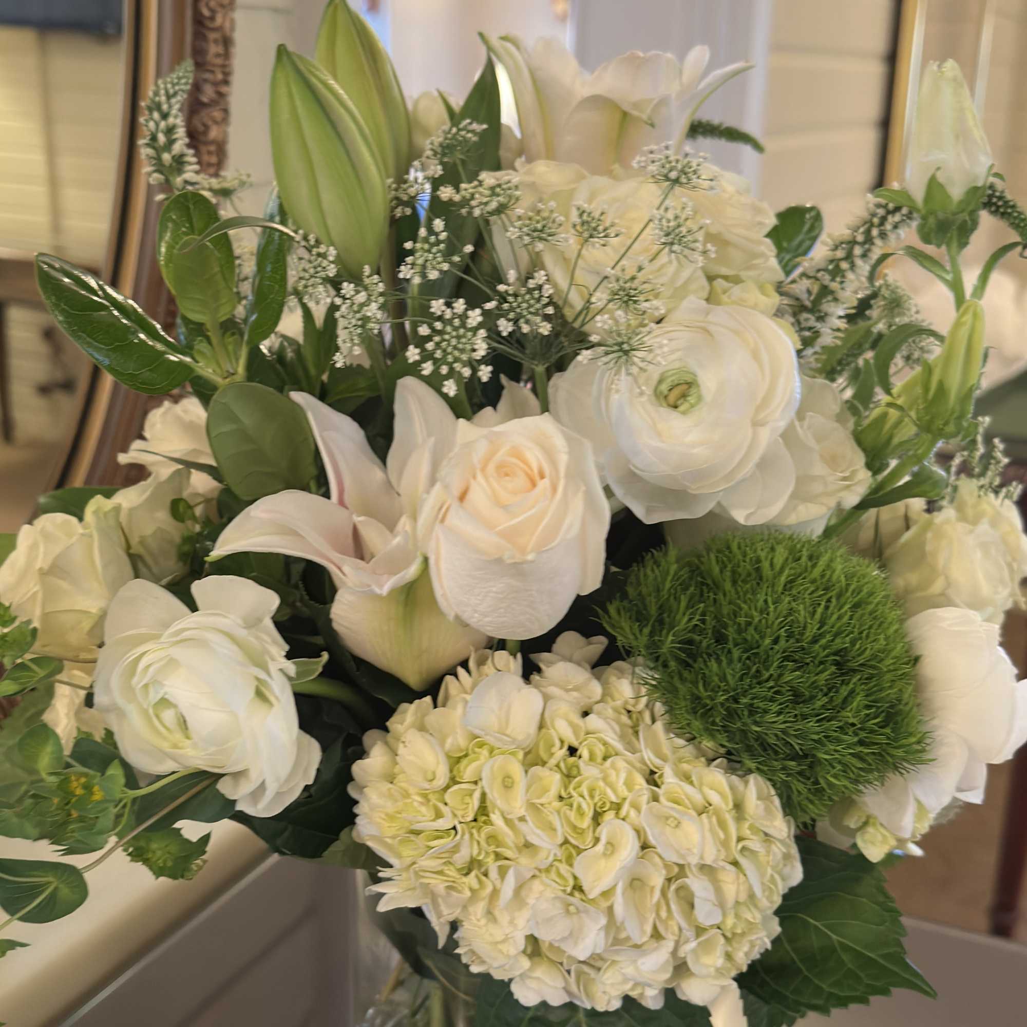 Handcrafted in a clear glass cylinder vase, the design pairs a structured