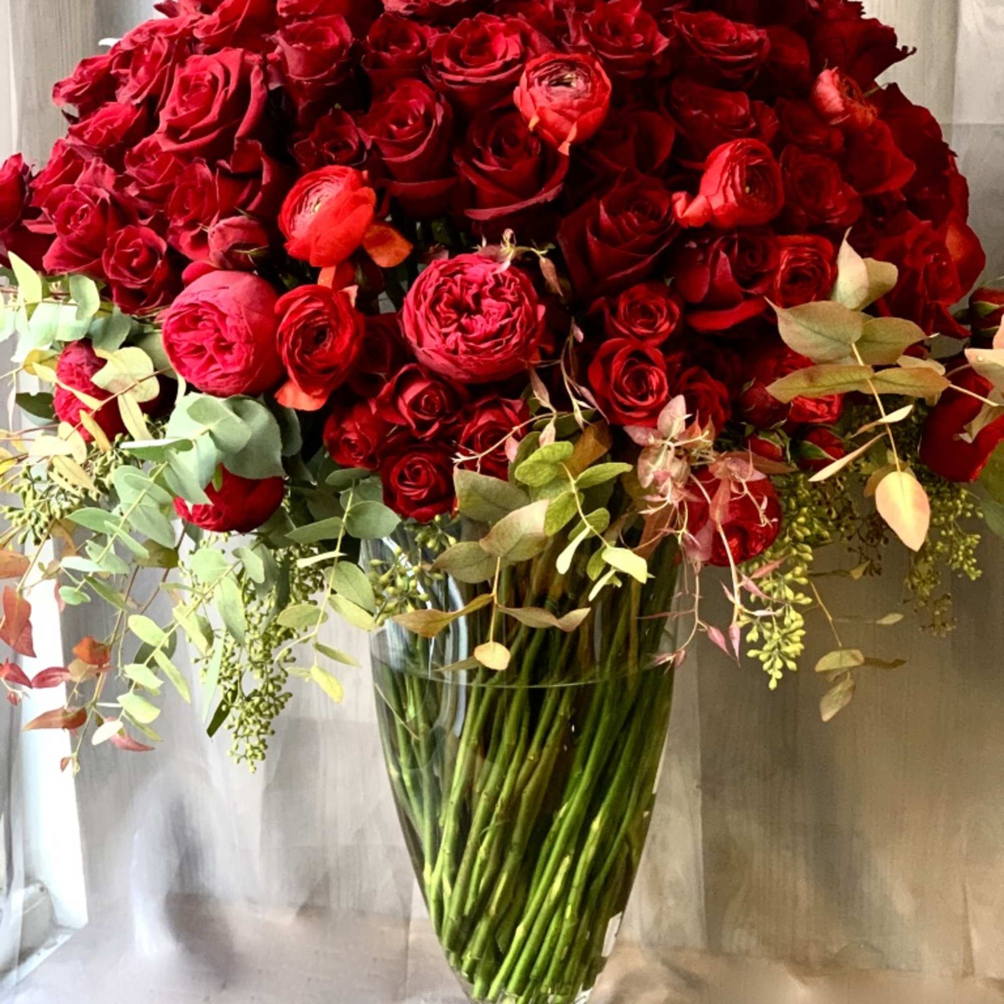 Large bouquet of red roses in a clear glass vase, photo 2 of 2