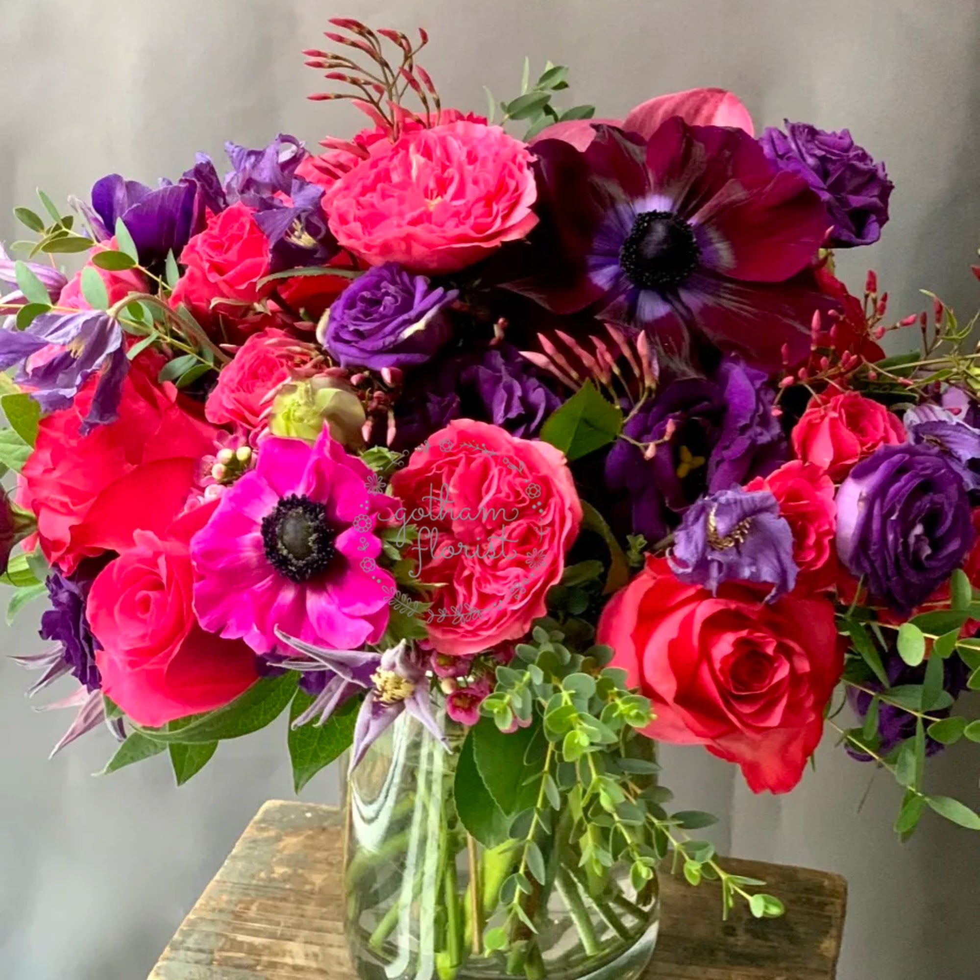 Bright pink and purple bouquet in a clear glass vase
