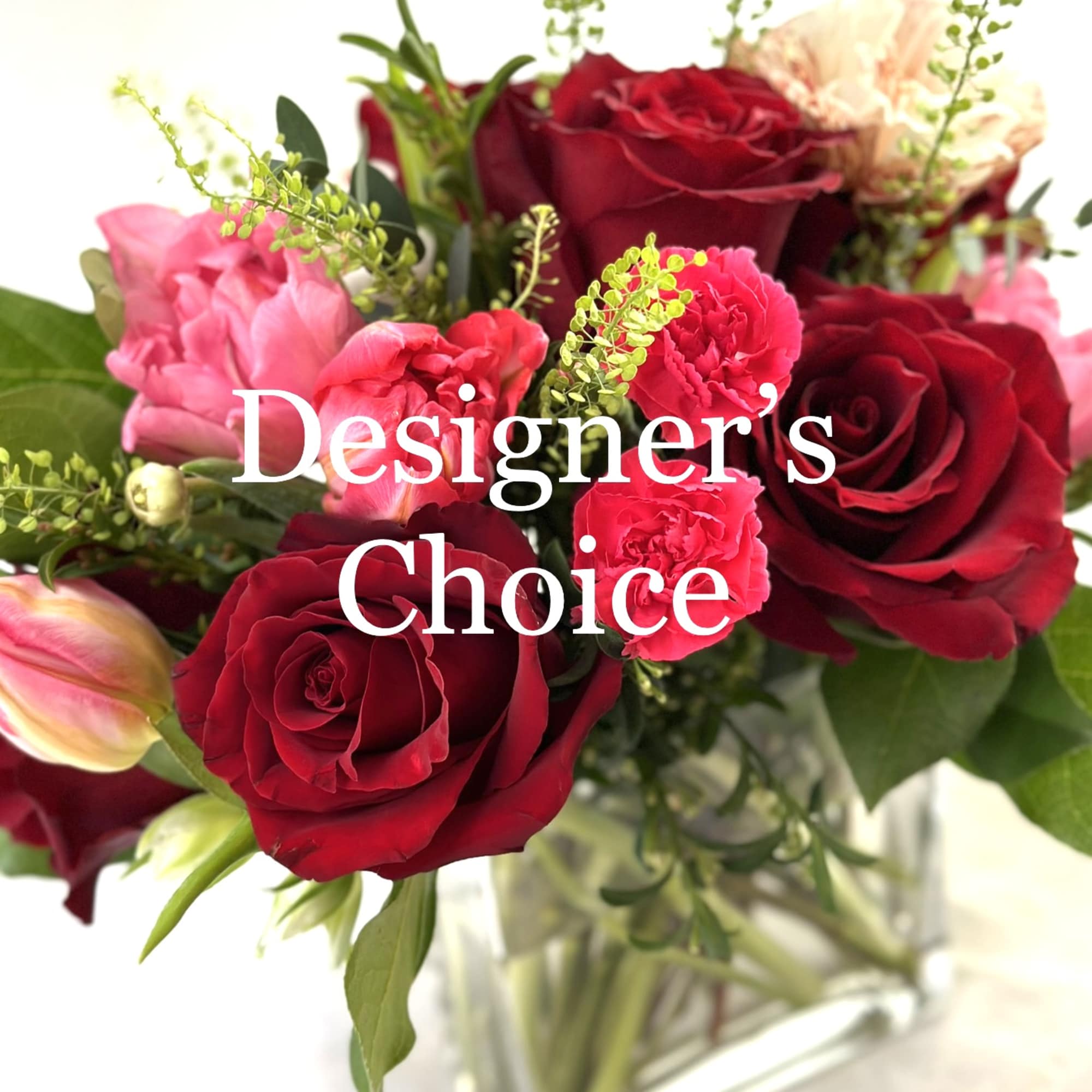 Bouquet of red and pink roses in a clear glass vase