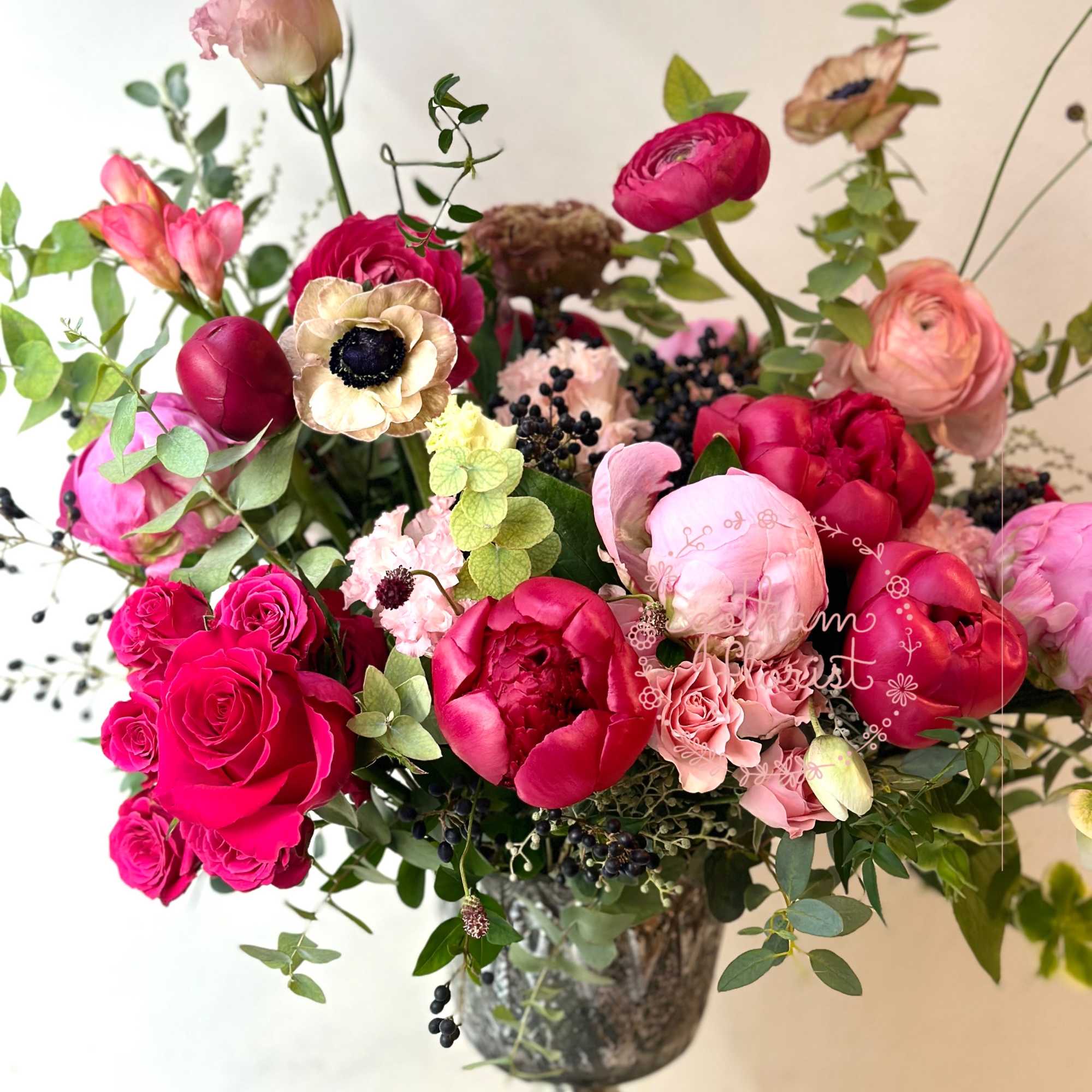 Pink and red mixed bouquet in a silver vase