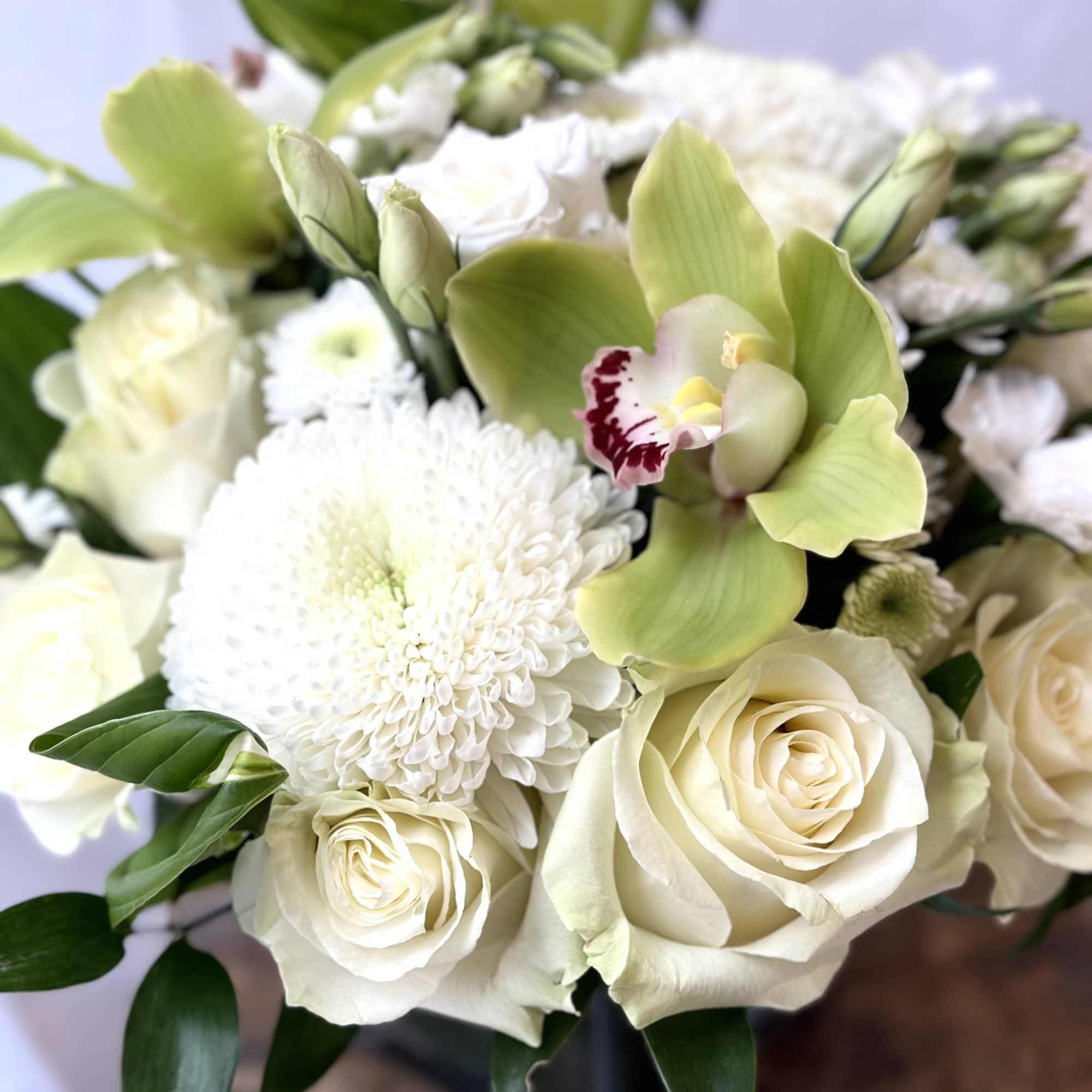 Bouquet of white roses, chrysanthemums, and green orchids
