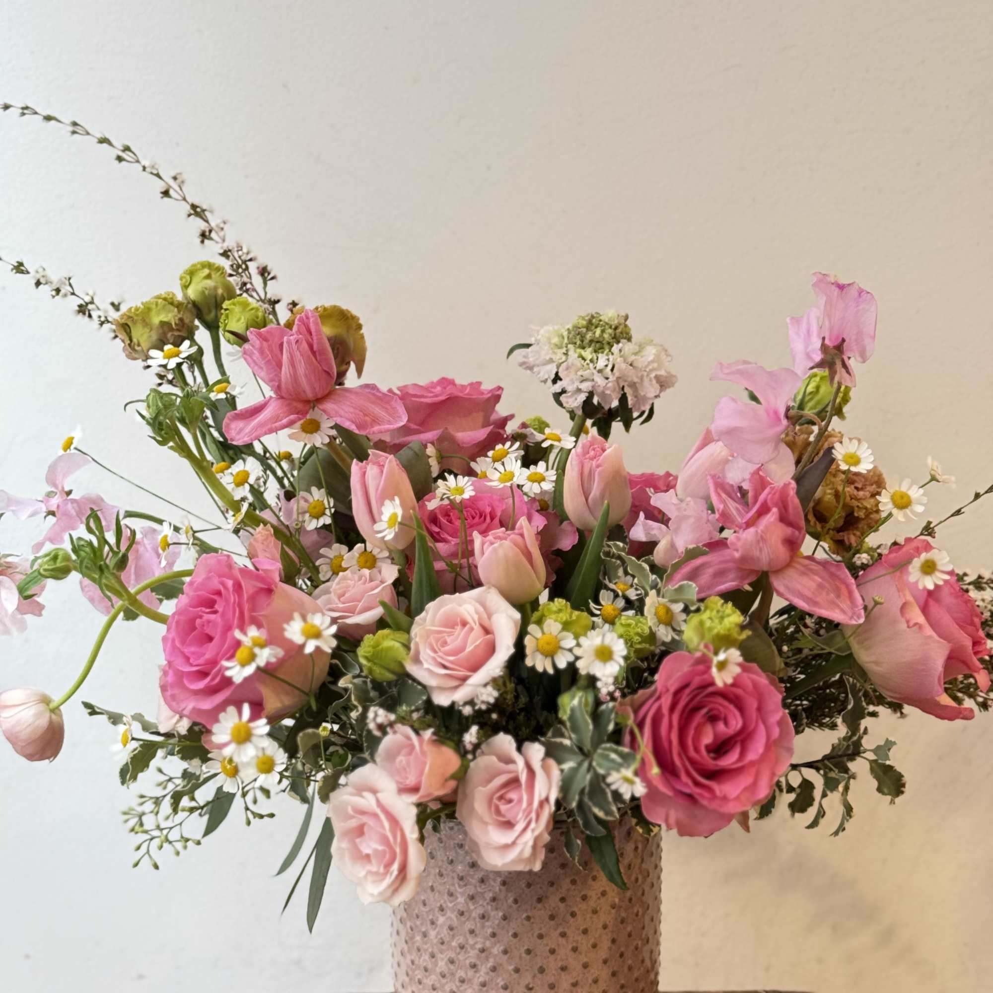 Pink and white mixed bouquet in a textured vase