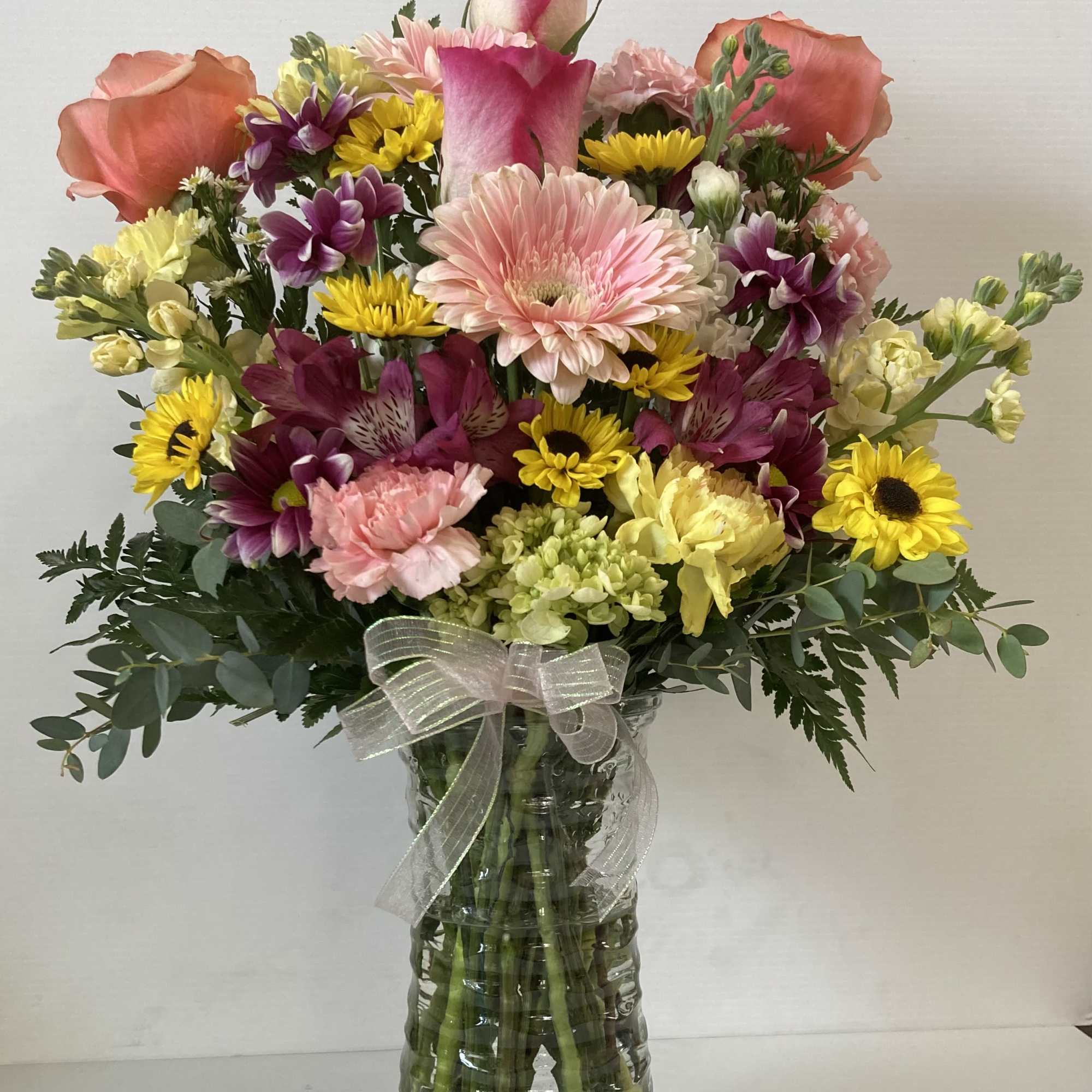 Arrangement includes roses, lilies, carnations, hydrangea, gerber daisy, filler and assorted greenery