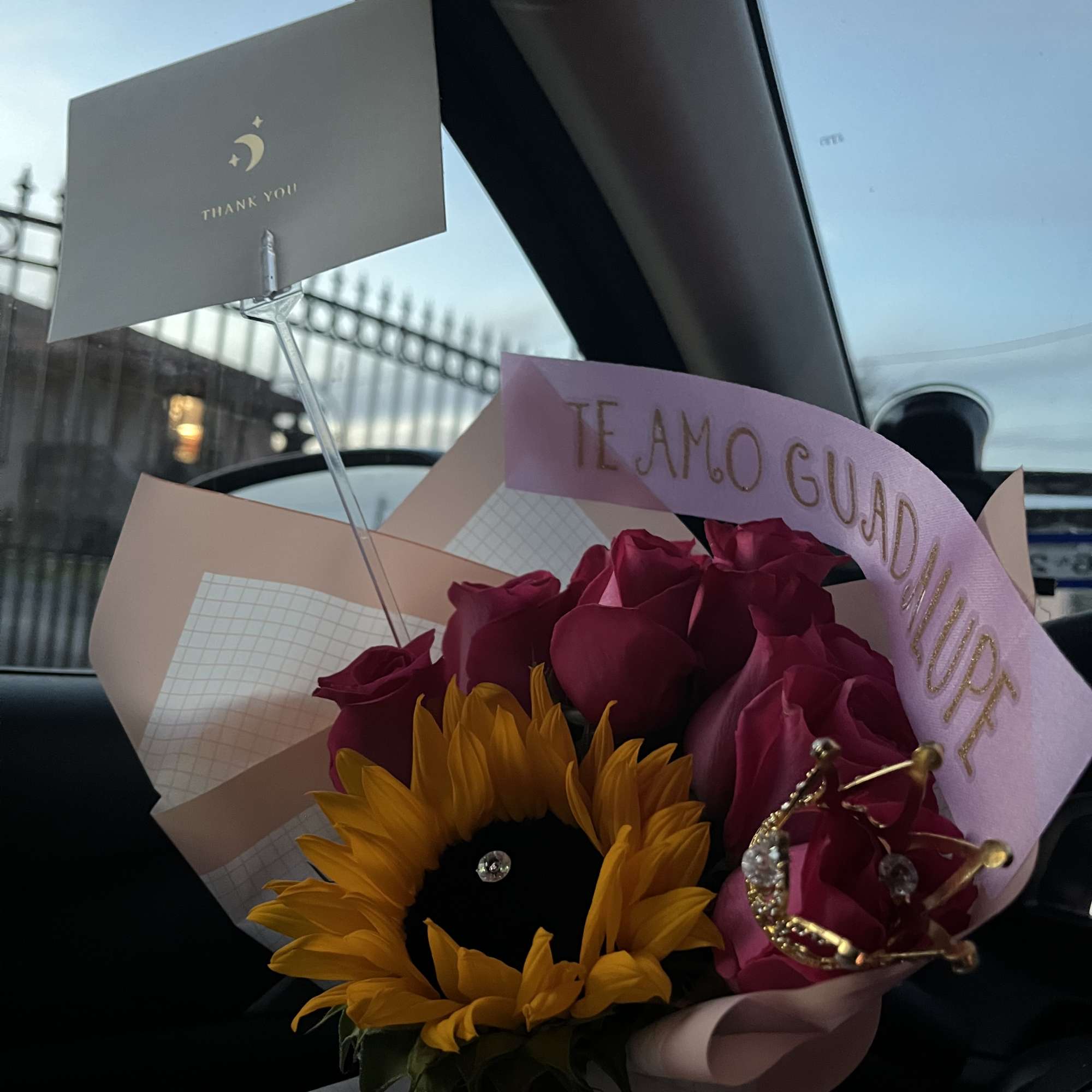 Bouquet of pink roses and a sunflower with decorative cards