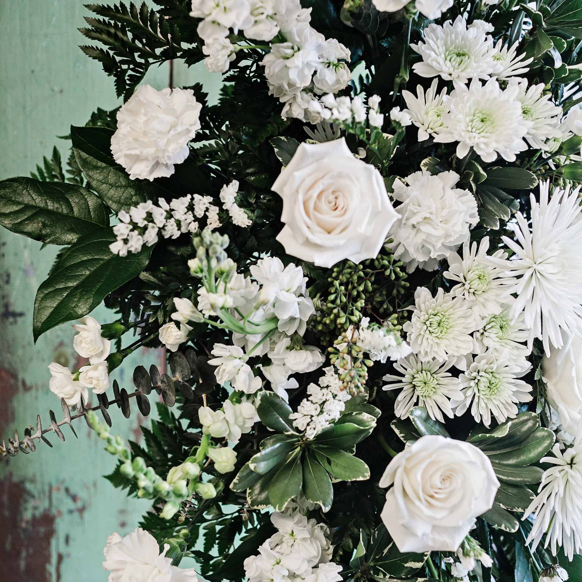 White roses and mixed white flowers in a lush arrangement