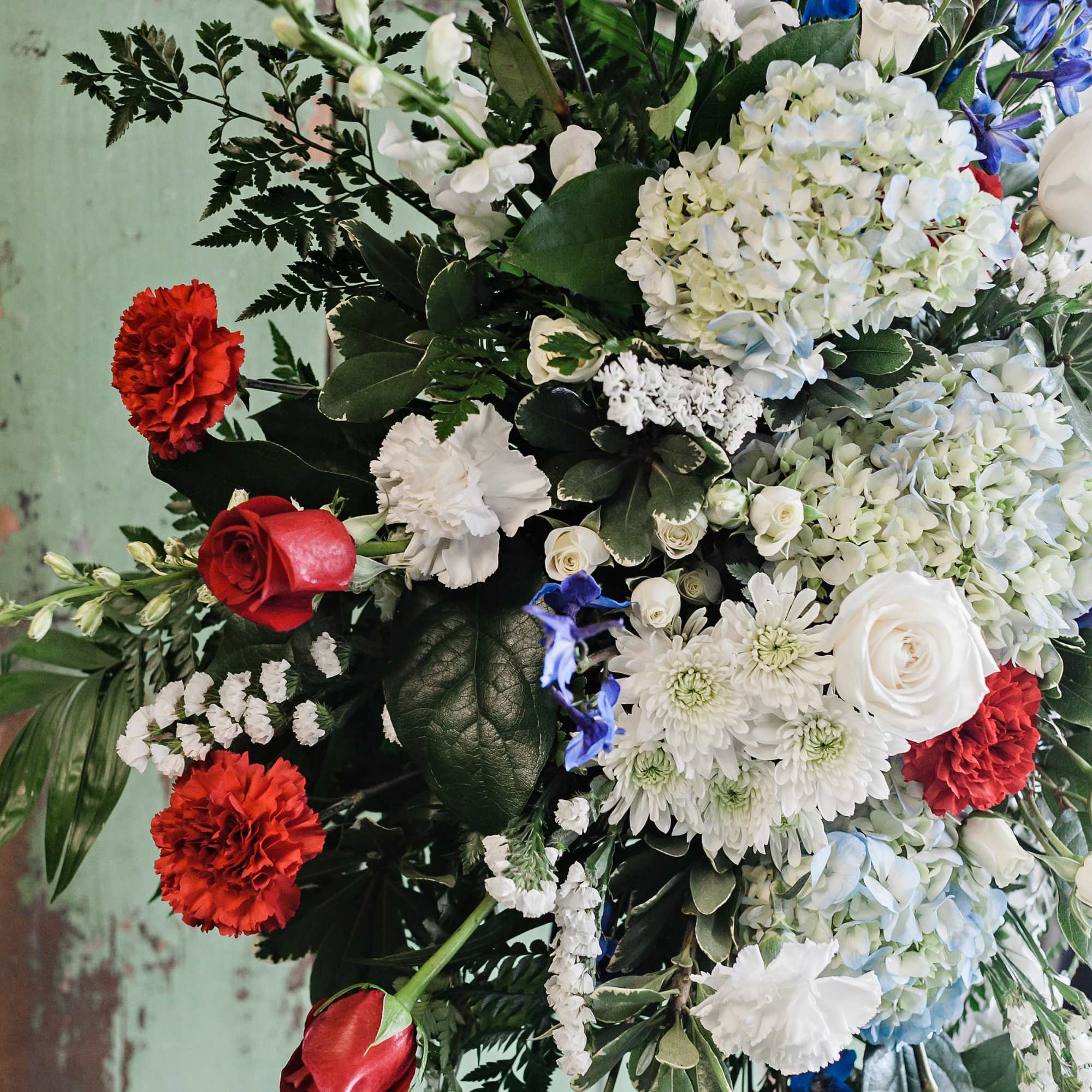 Large mixed floral arrangement with red, white, and blue blooms