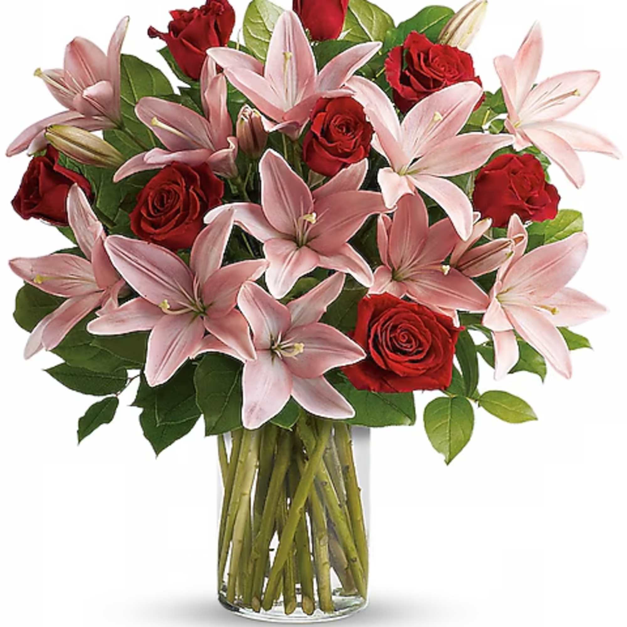 Bouquet of red roses and pink lilies in a clear glass vase