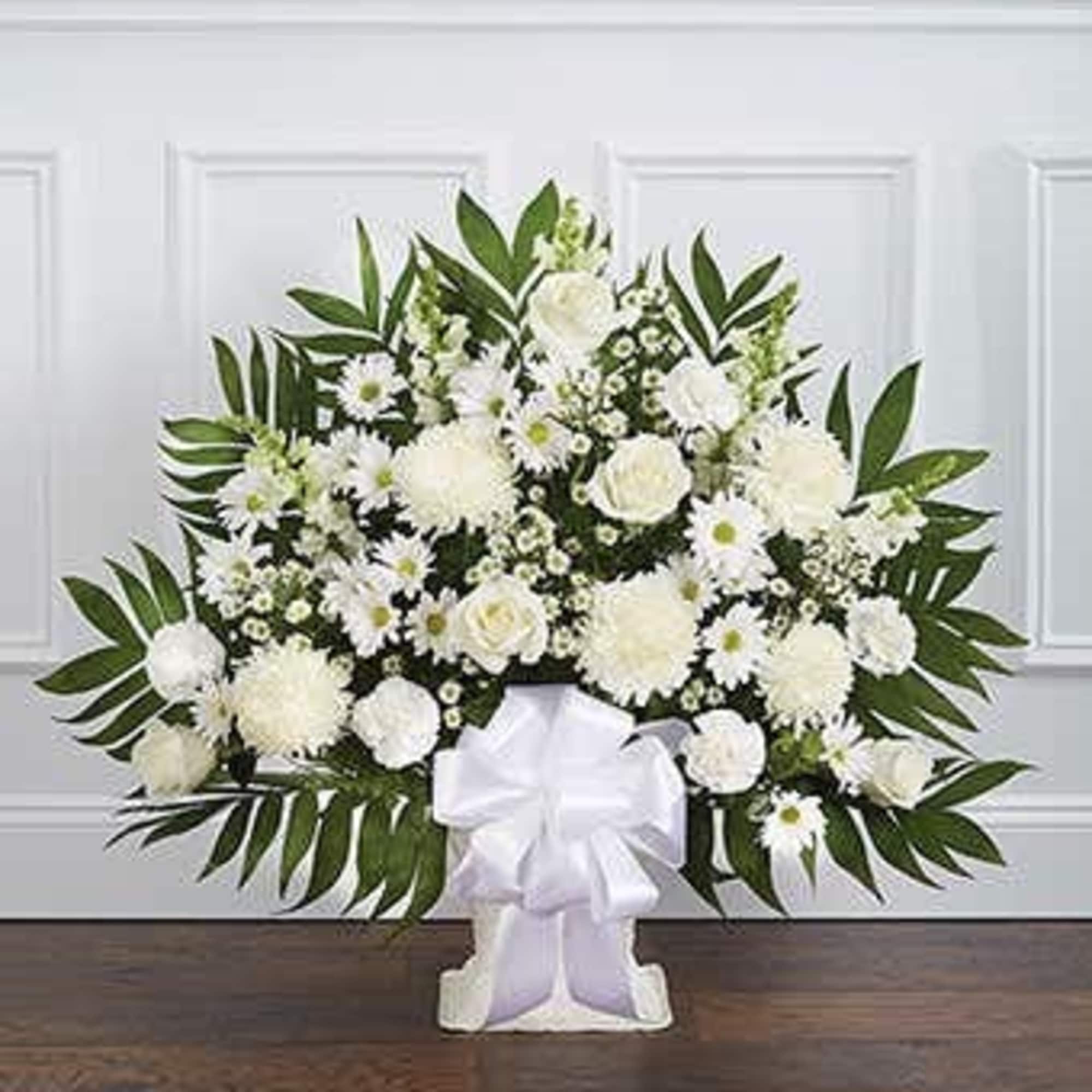 A beautiful sympathy floor basket hand arranged with stunning white flowers. Created