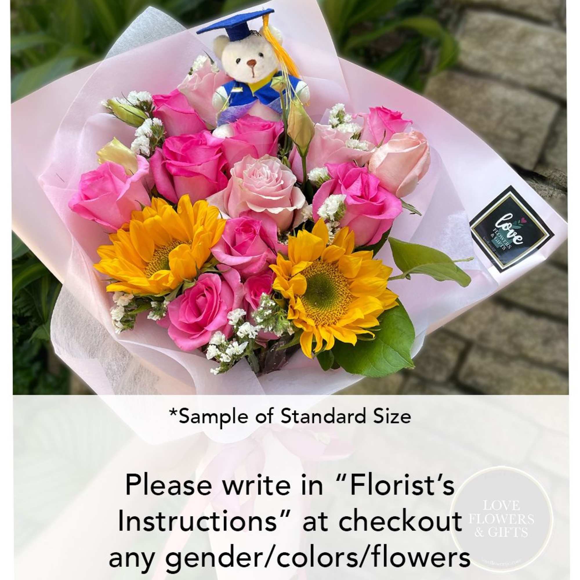 Bouquet of pink roses and yellow sunflowers wrapped in pink paper with a small graduation teddy bear.