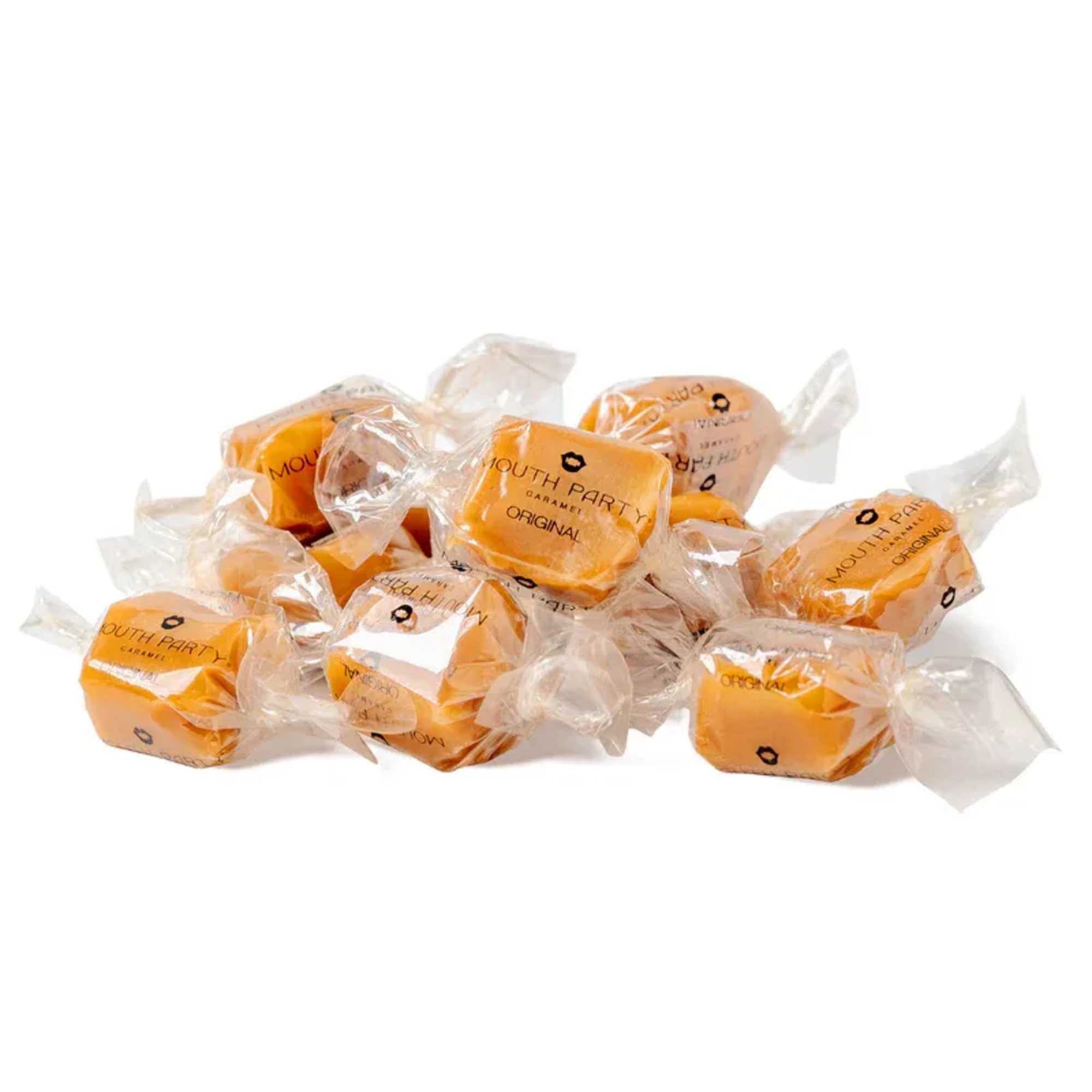 Individually wrapped caramel candies piled on a white background