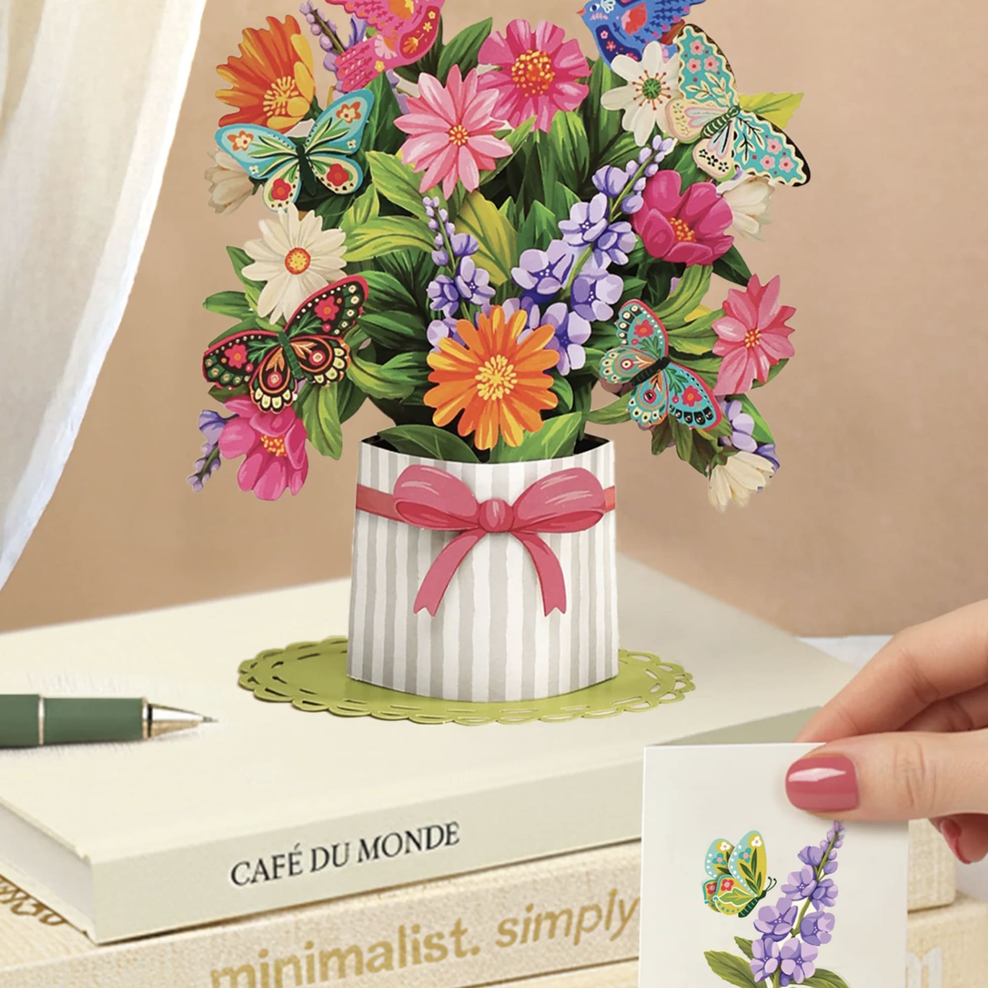 Pop-up bouquet card with colorful flowers and butterflies in a striped vase