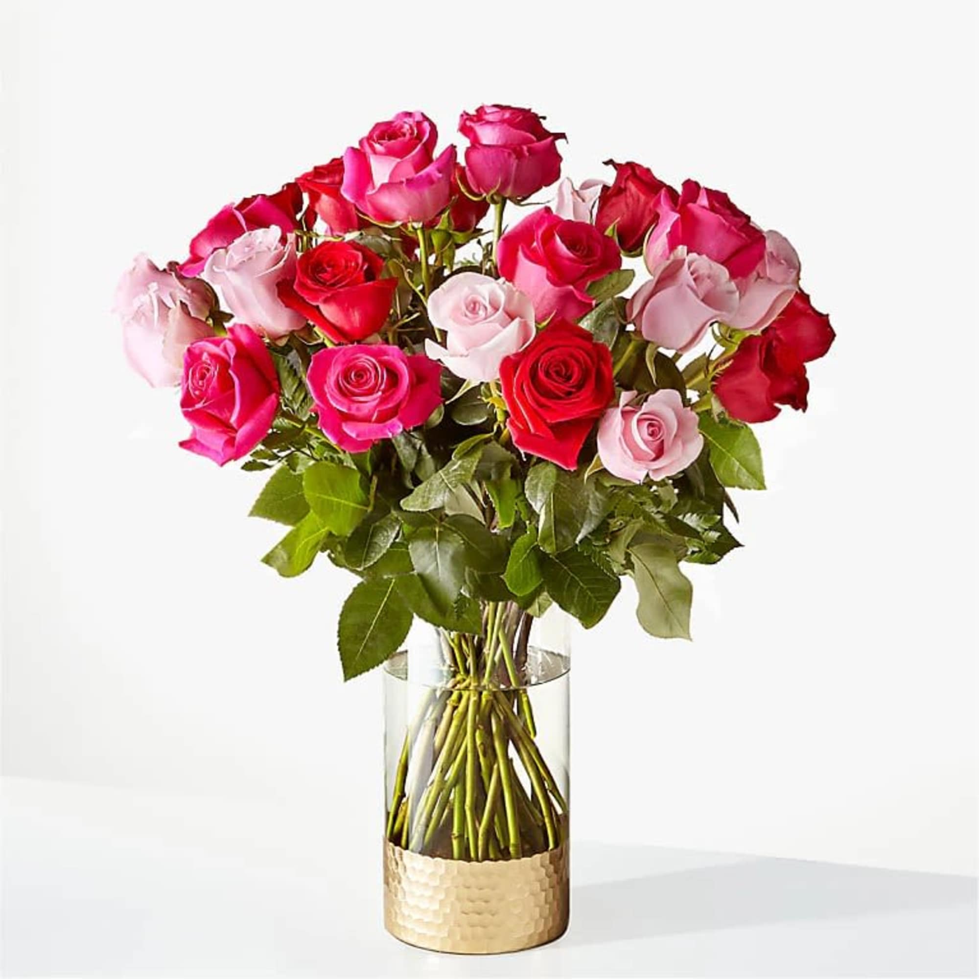 Bouquet of pink and red roses in a clear glass vase