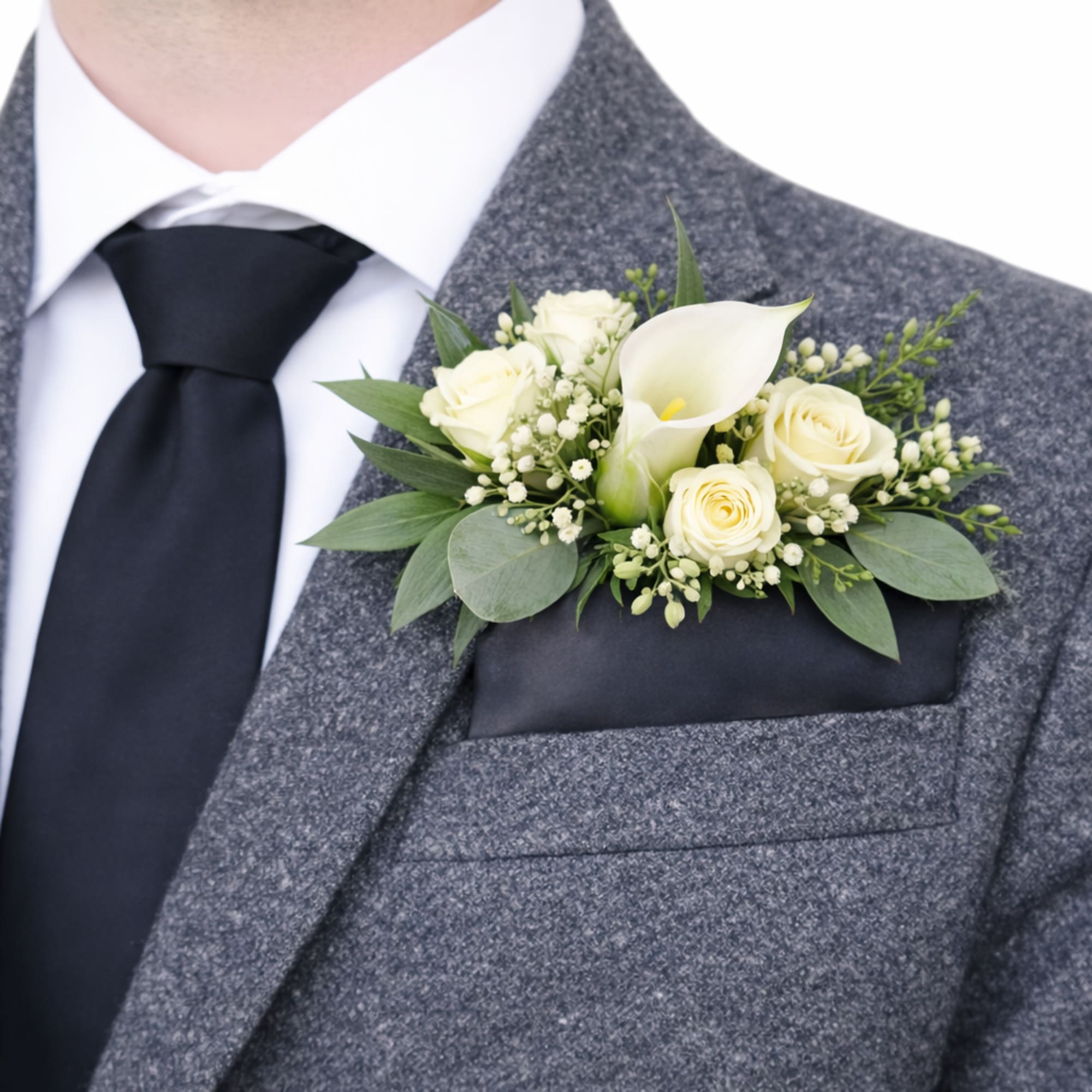 White rose and calla lily pocket boutonniere on a grey suit jacket