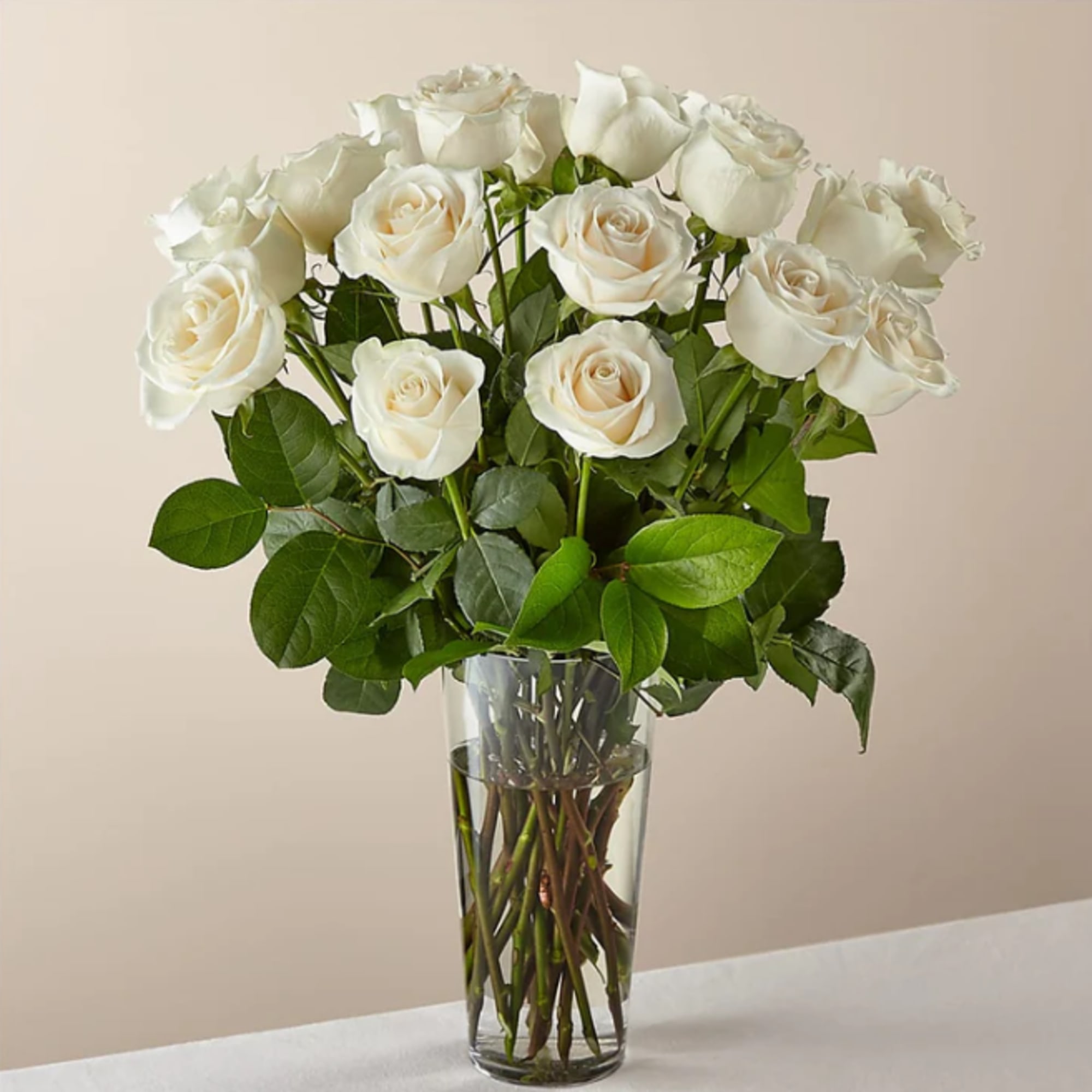White roses arranged in a clear glass vase