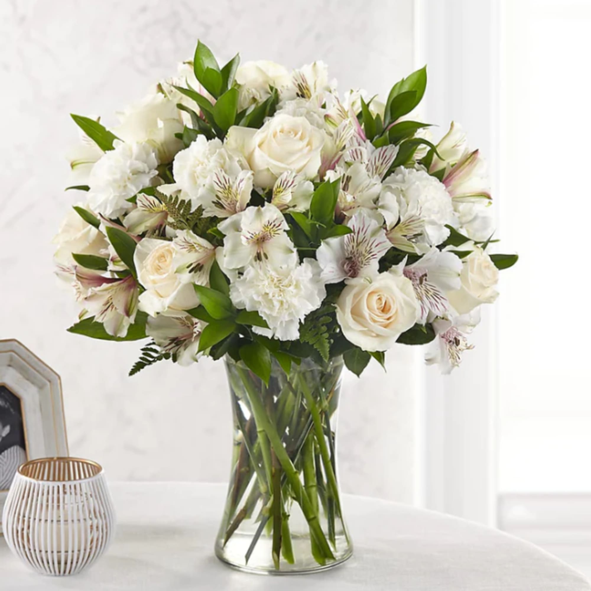 White roses and alstroemeria in a clear glass vase