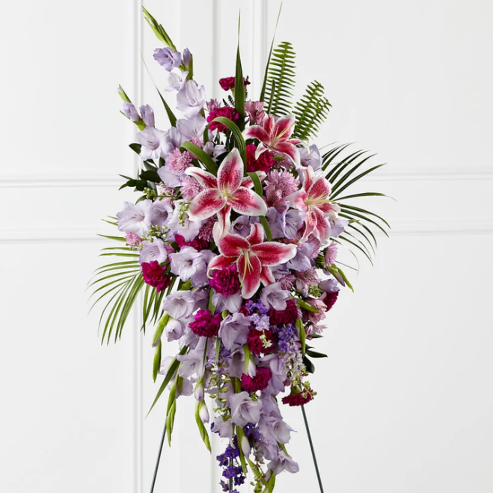 Tall standing spray of pink lilies and lavender flowers