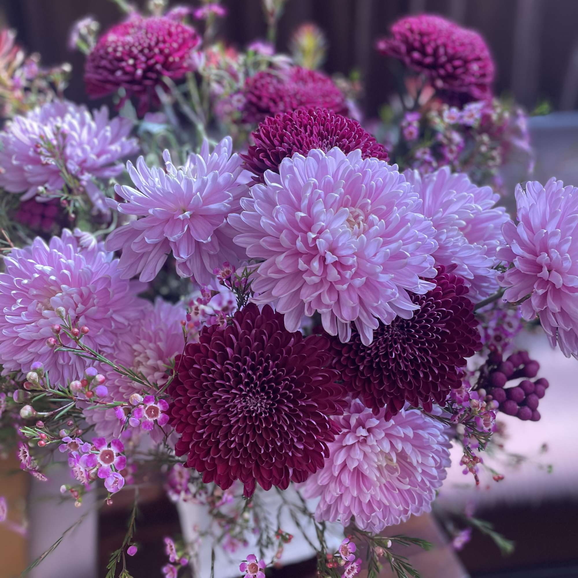 Bouquet of pink and magenta chrysanthemums with small pink filler flowers