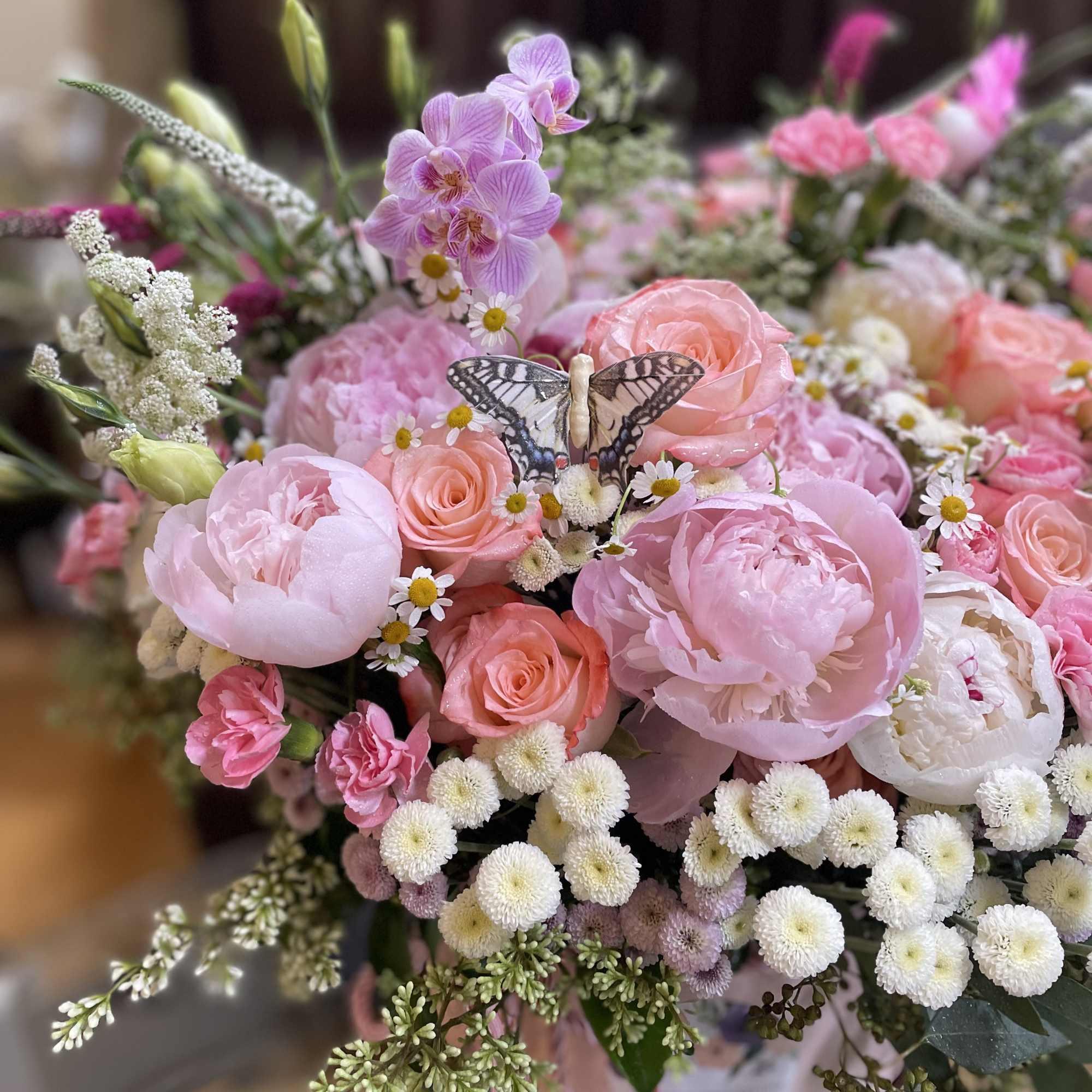 Pink and peach bouquet with a butterfly accent