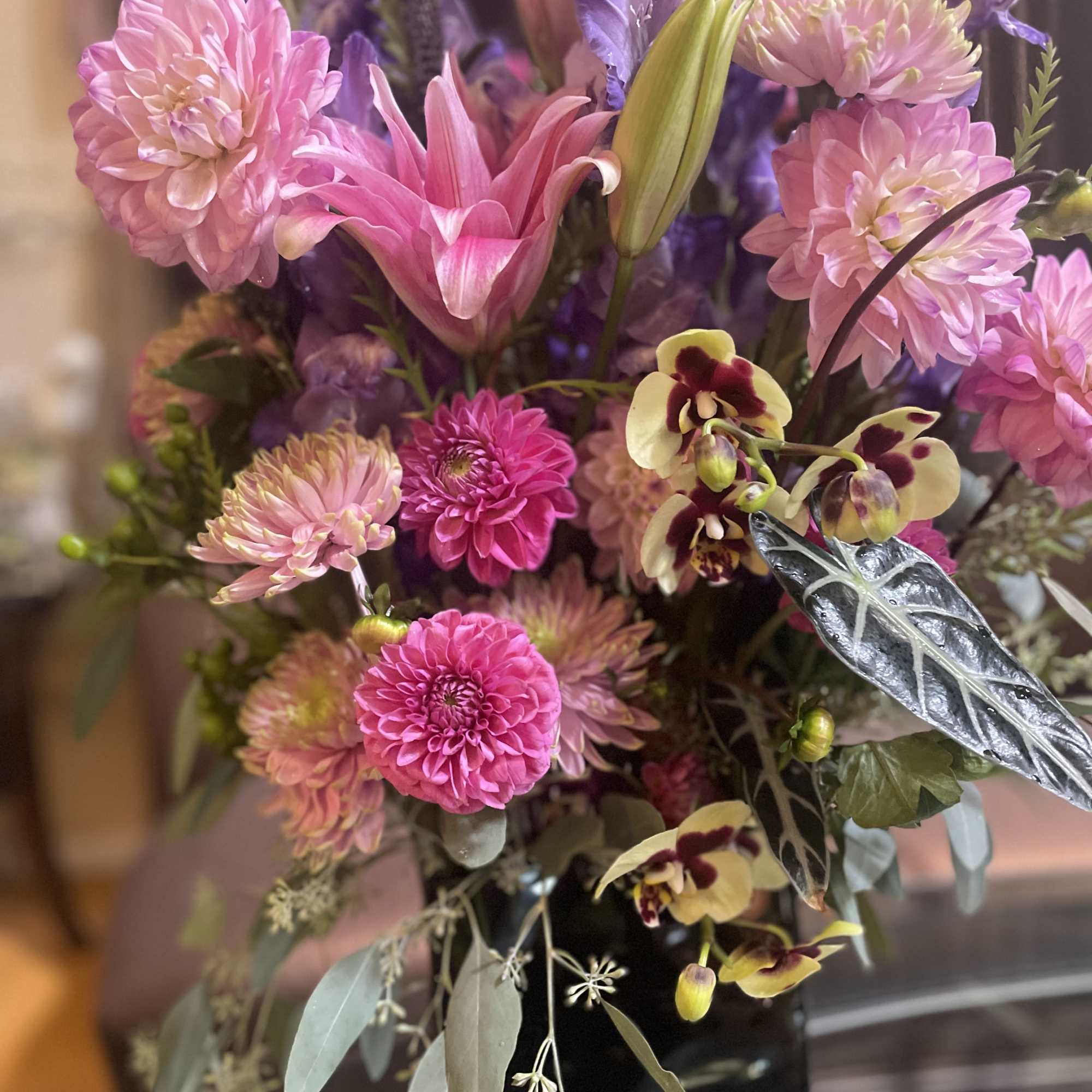Pink and purple mixed bouquet in a black vase