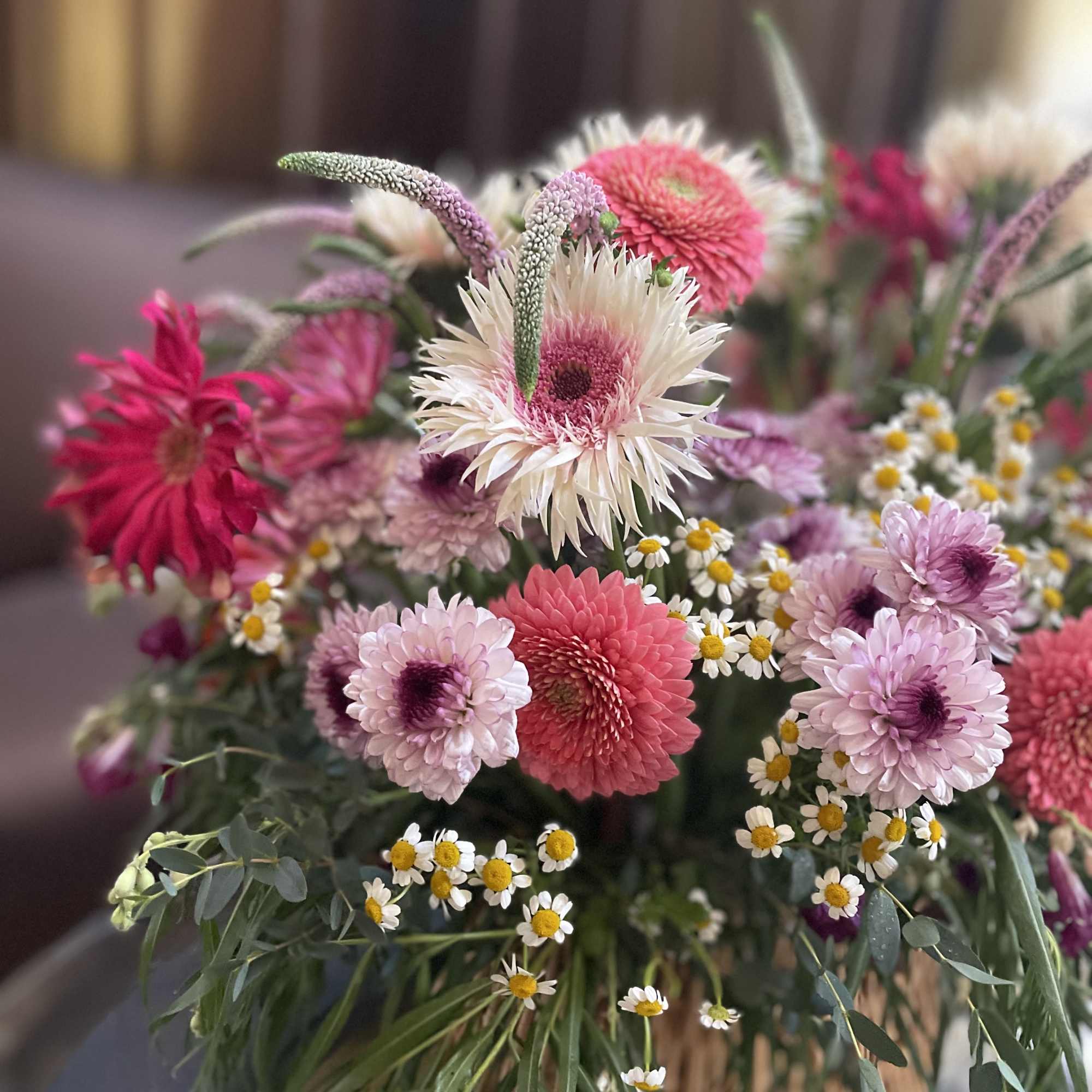 Mixed bouquet of pink and white flowers with small daisies