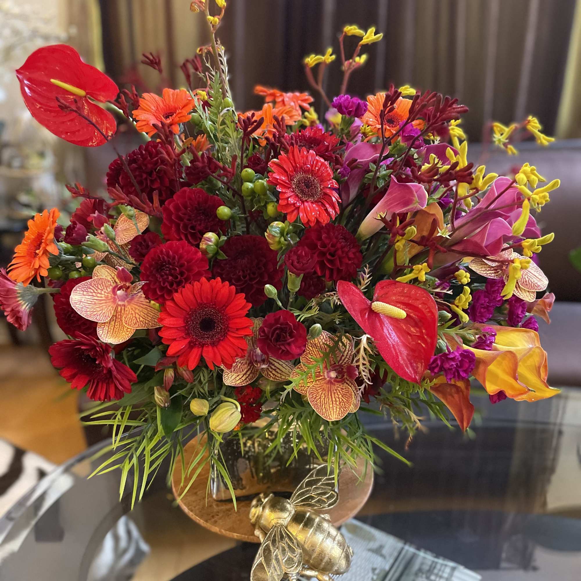 Bright mixed bouquet with red, orange, pink, and yellow flowers in a vase