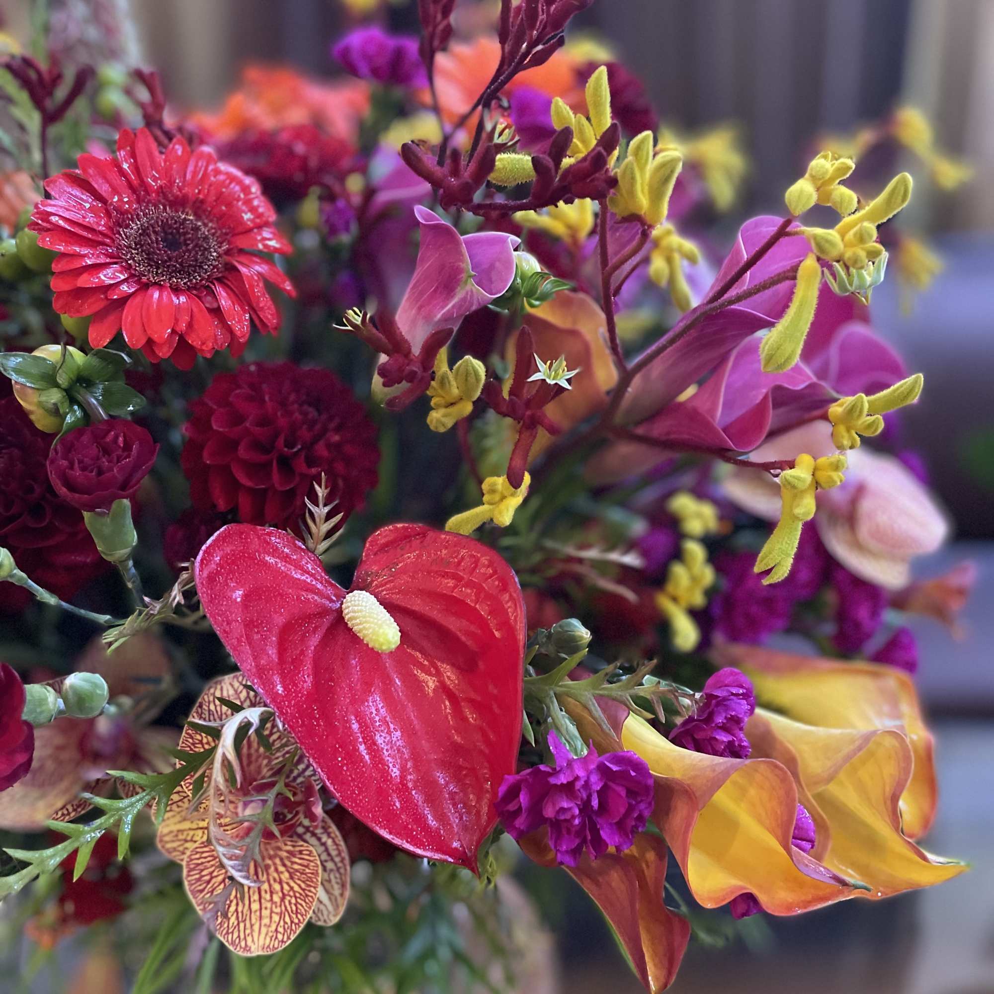 Bright mixed bouquet with red, pink, and yellow tropical blooms