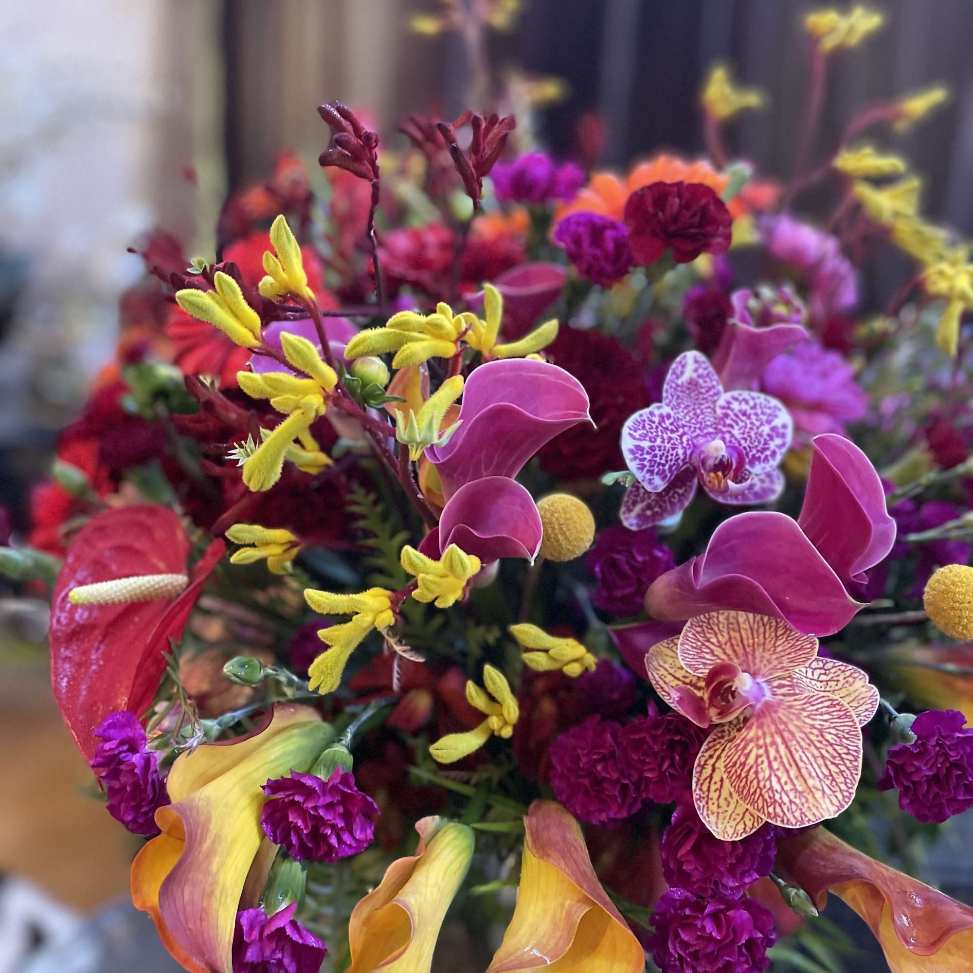 Bright mixed bouquet with orchids, calla lilies, and carnations