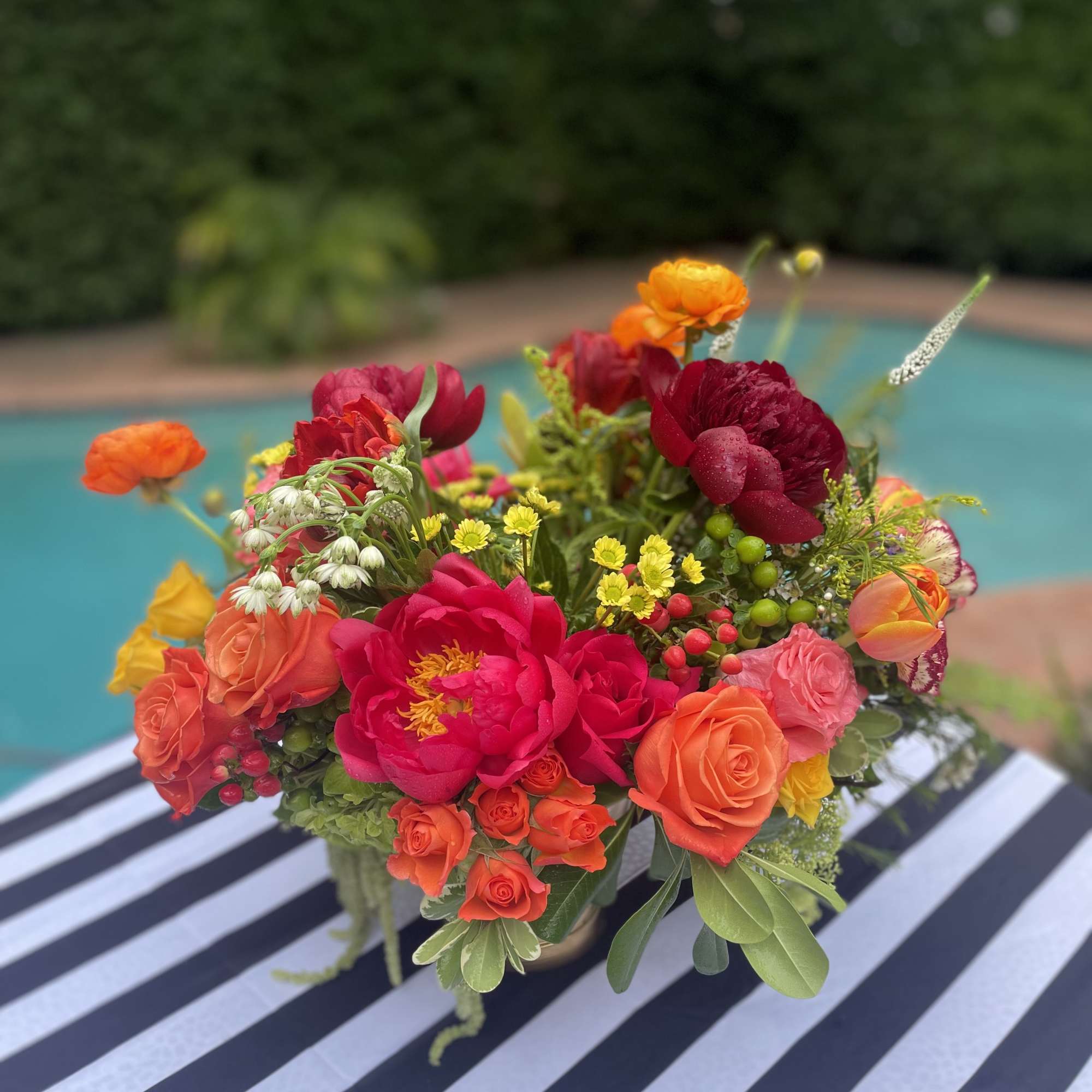 Bright mixed bouquet of roses and peonies in a vase