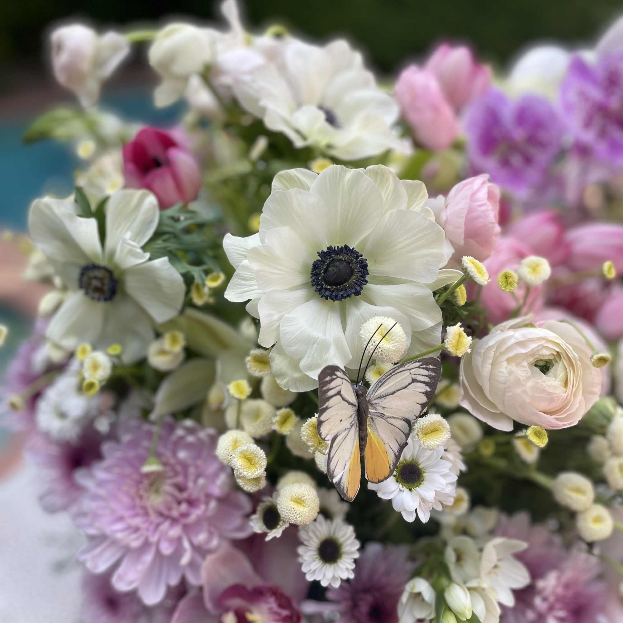 Bouquet of white and pink flowers with a butterfly decoration