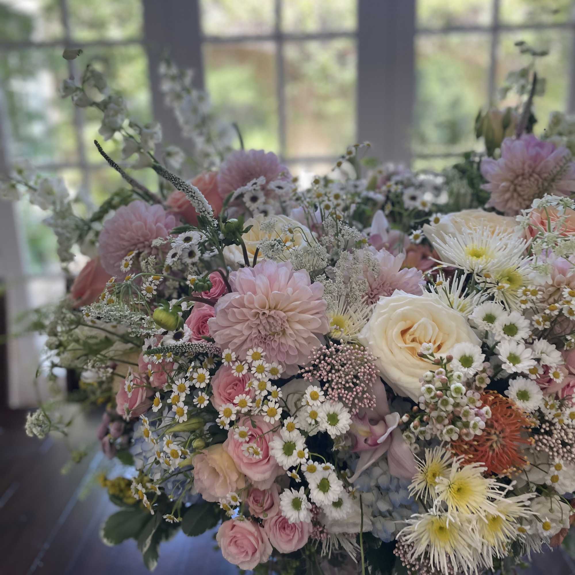 Large pastel bouquet with pink and white flowers in a vase
