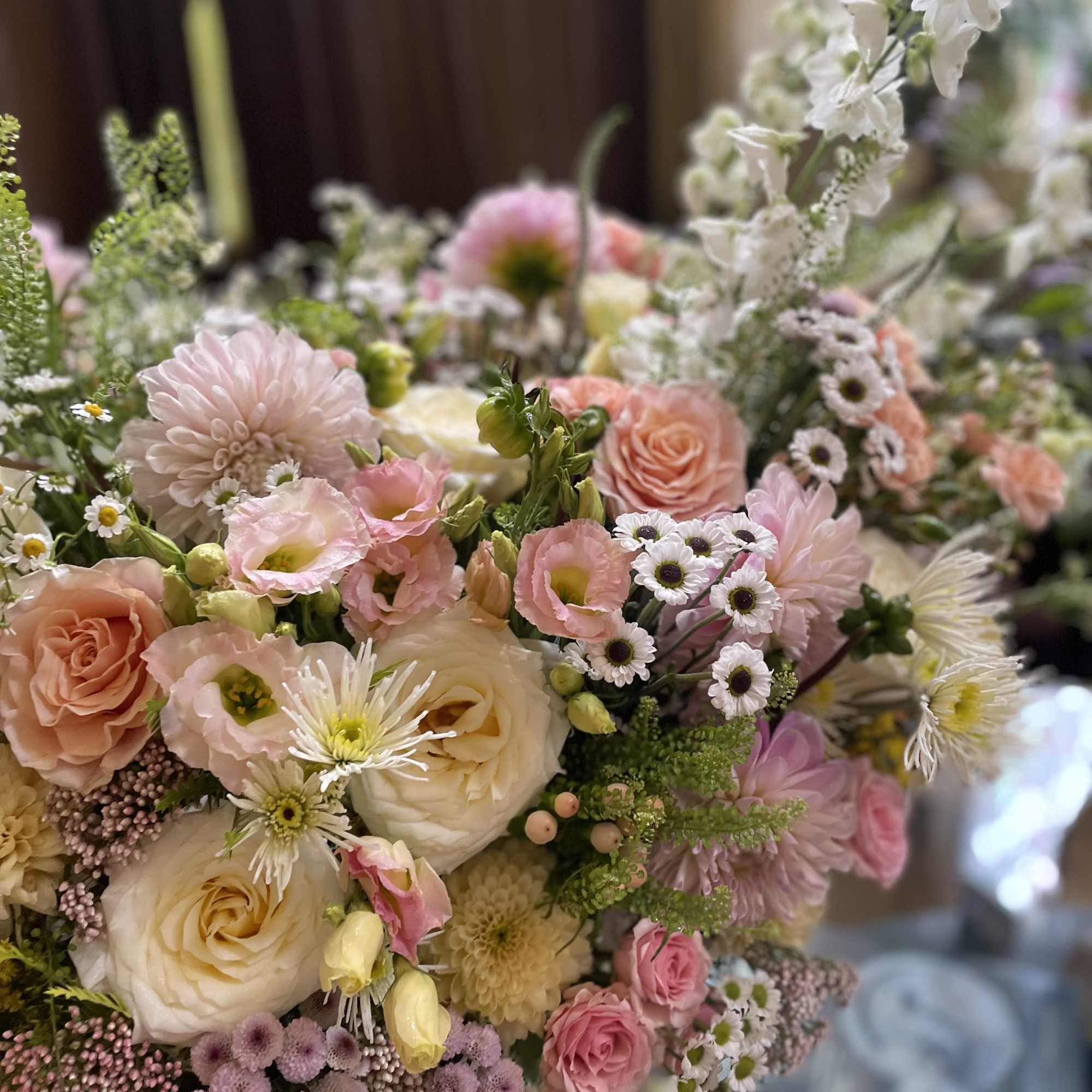 Pastel bouquet with roses, dahlias, and small daisy flowers