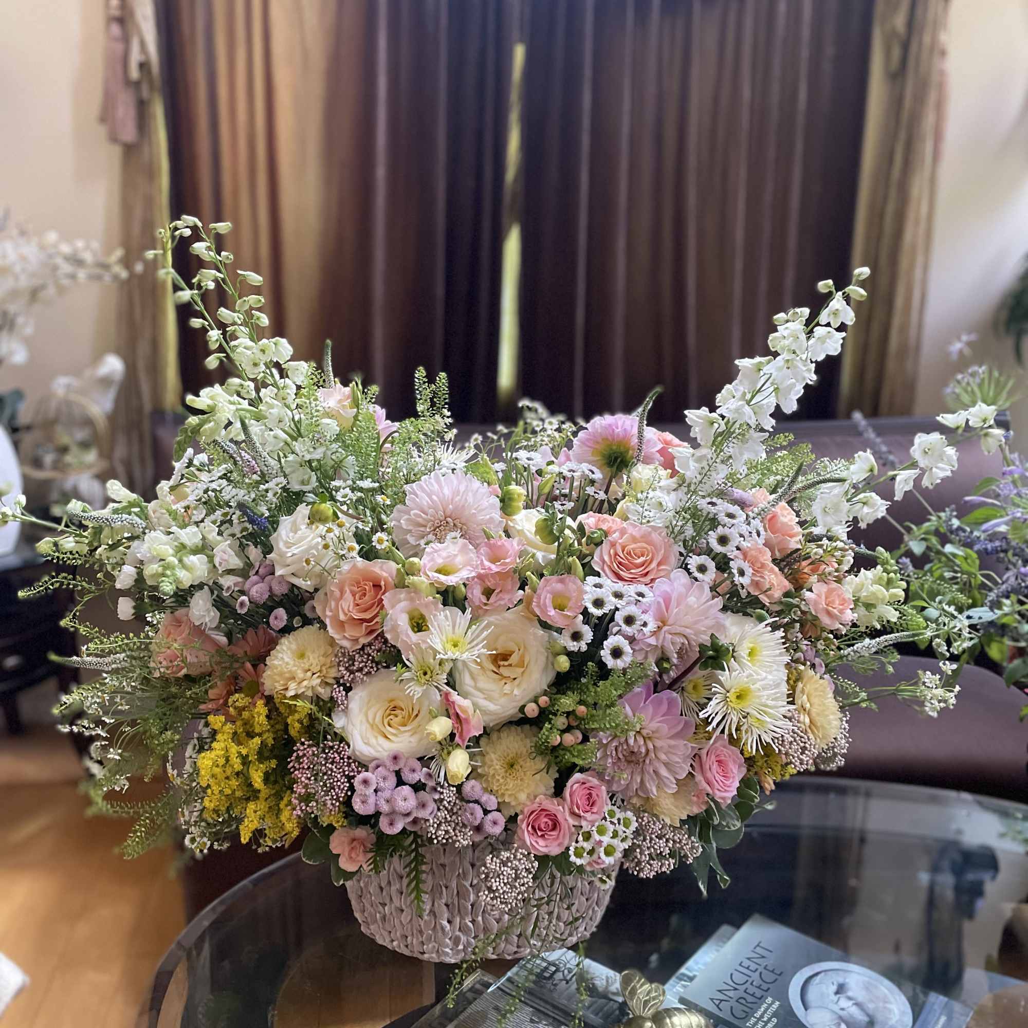 Large pastel flower arrangement in a woven basket, photo 9 of 10
