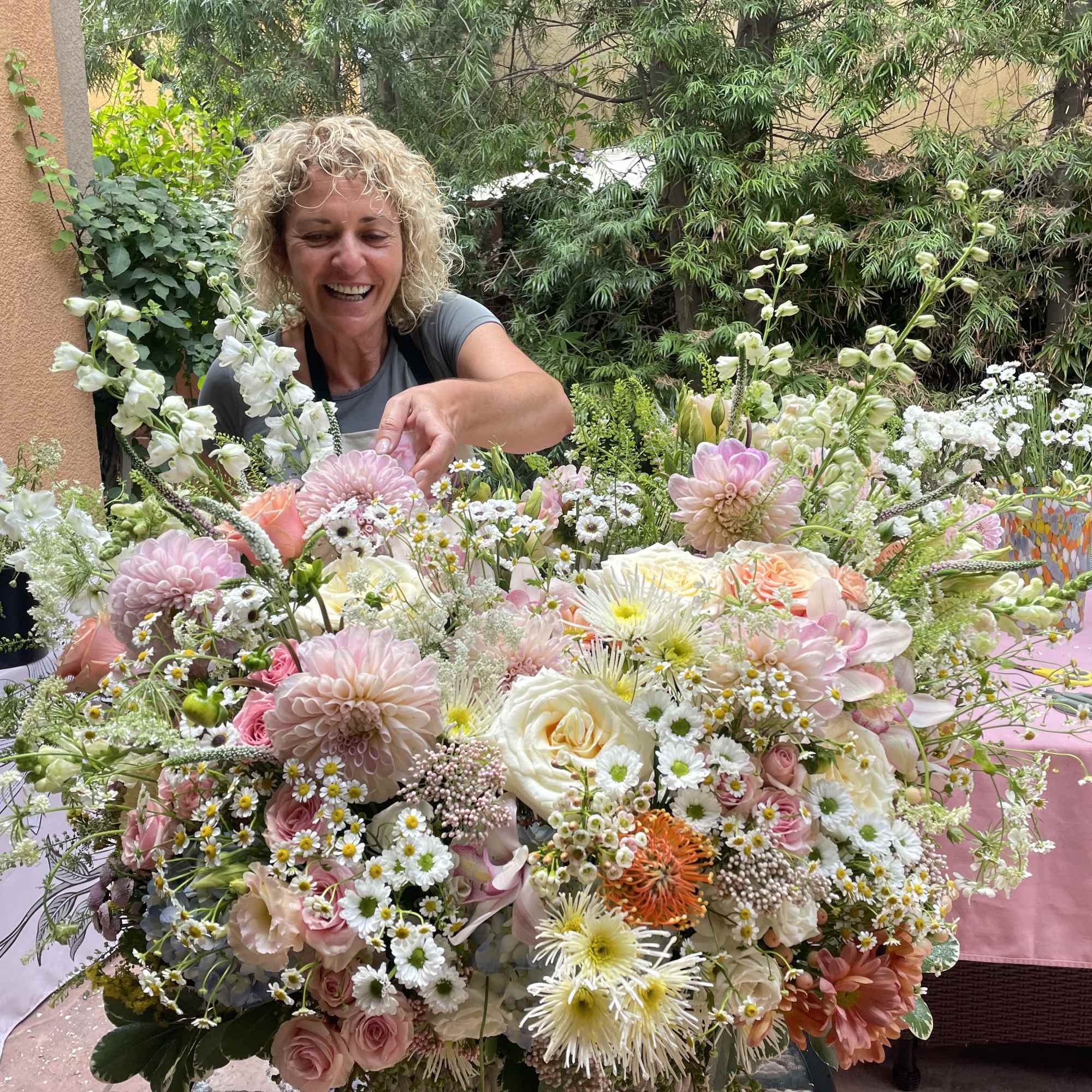 Large pastel flower arrangement with roses, daisies, and dahlias
