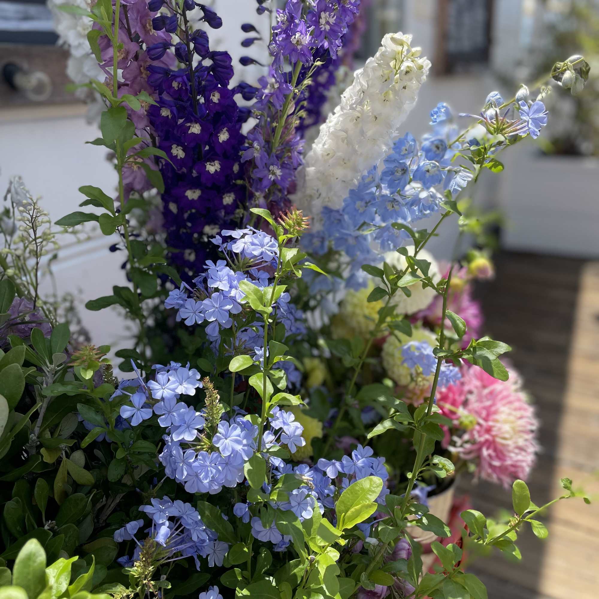 Tall mixed bouquet of purple, blue, and white flowers